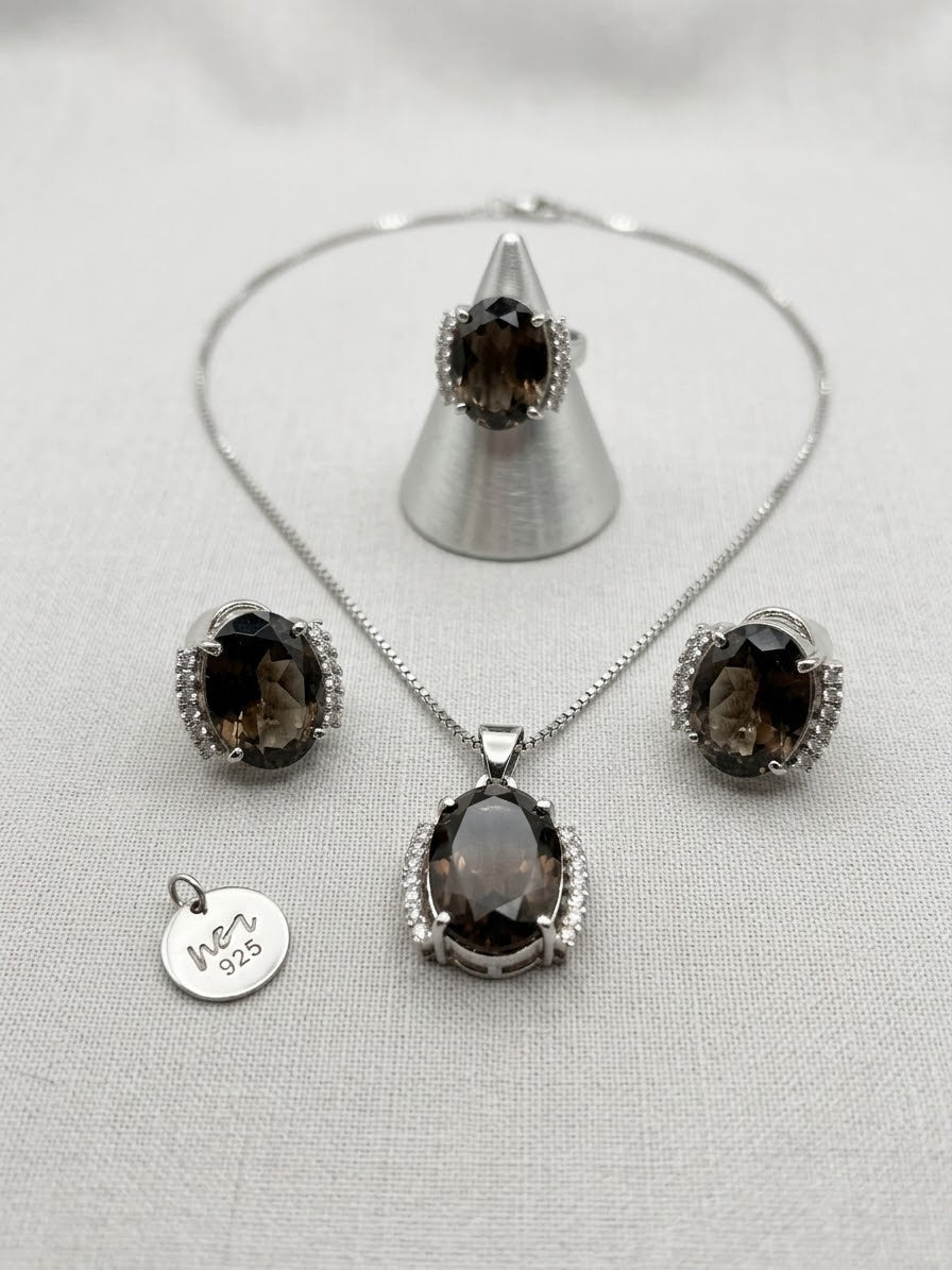 Niz & Aly smoky quartz jewelry set featuring an oval pendant, matching earrings, and a ring with silver accents.