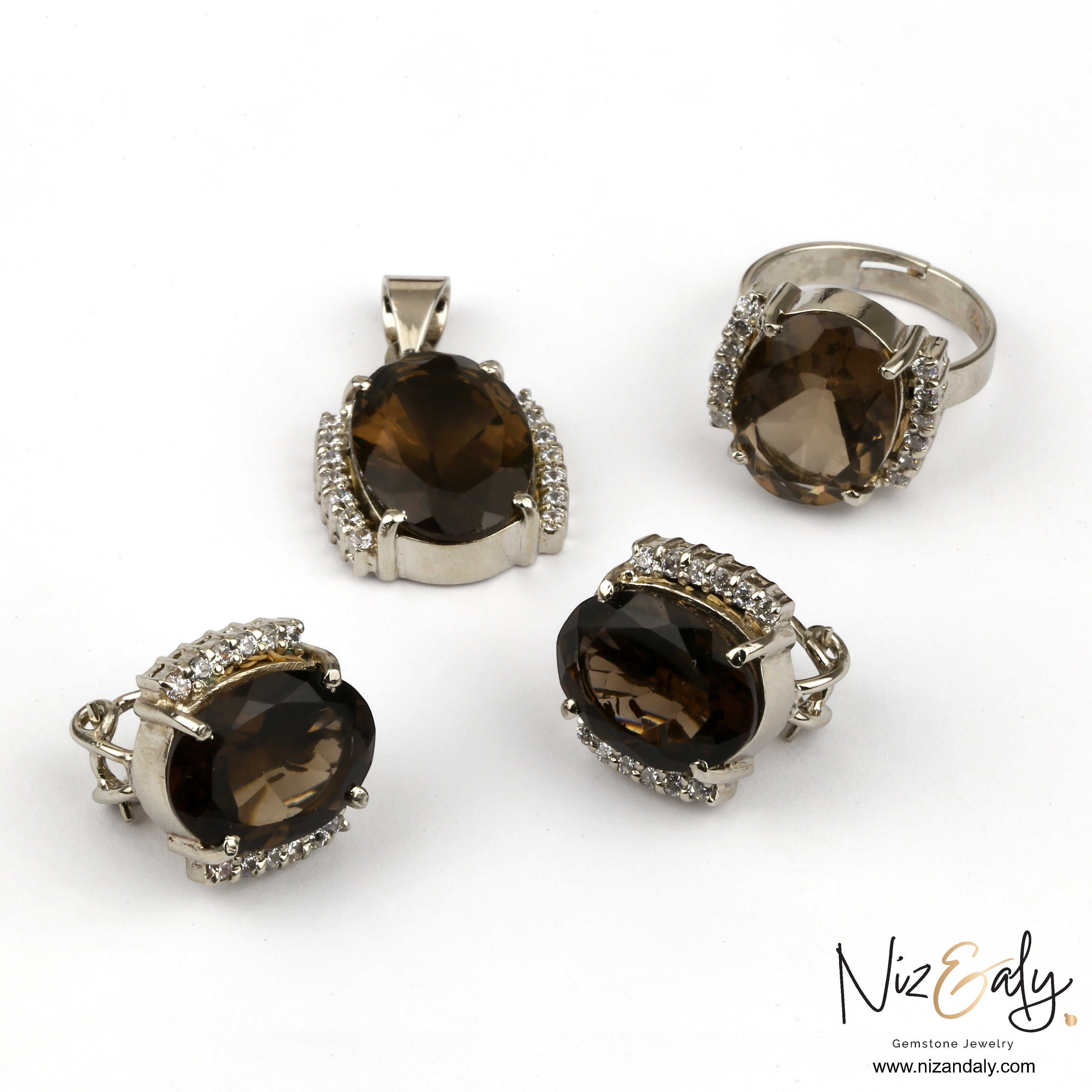 Niz & Aly smoky quartz jewelry set featuring an oval brown gemstone pendant, ring, and earrings with crystal accents.
