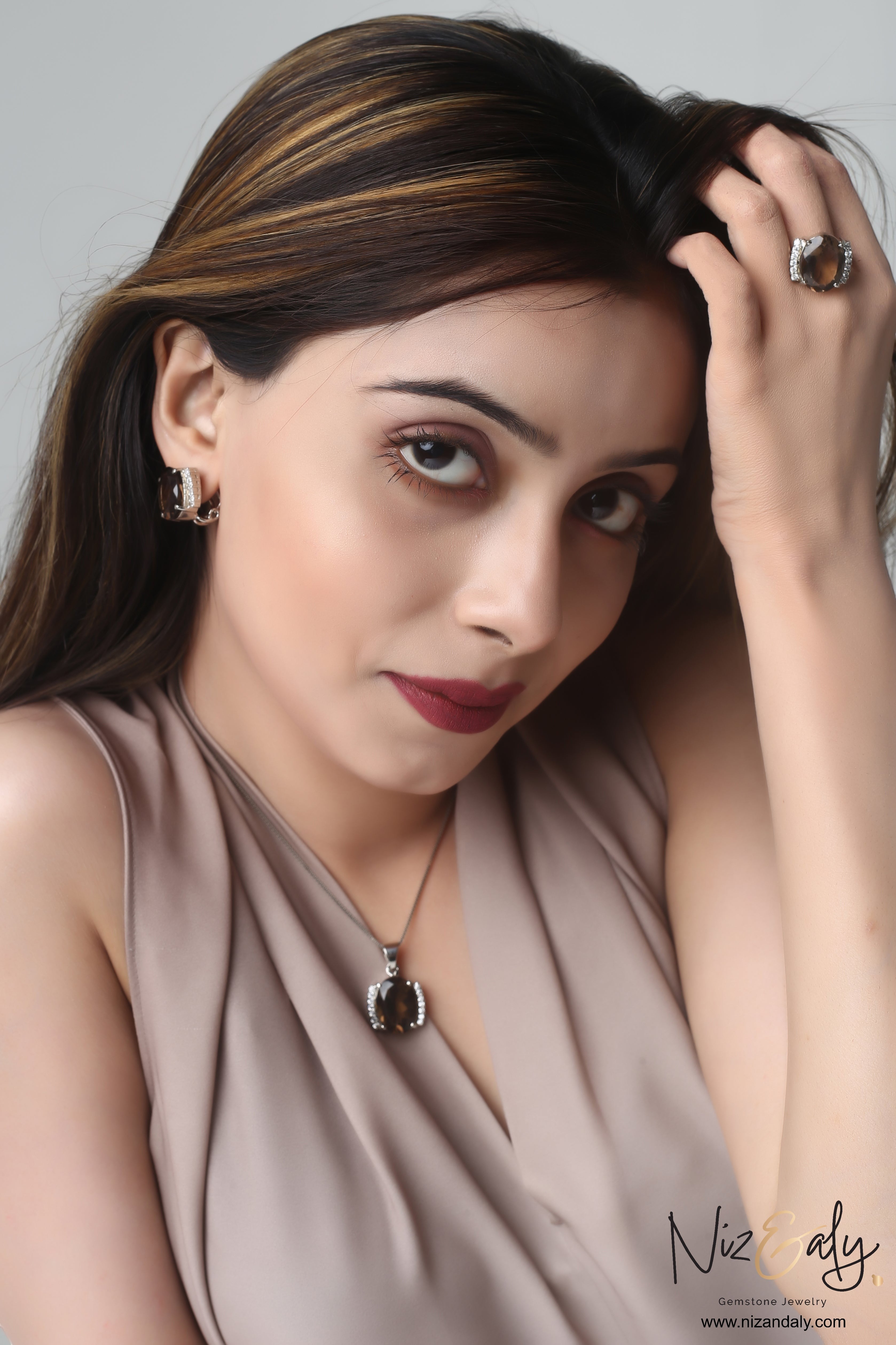 Niz & Aly smoky quartz pendant set featuring a faceted brown gemstone necklace, matching earrings, and a statement ring.