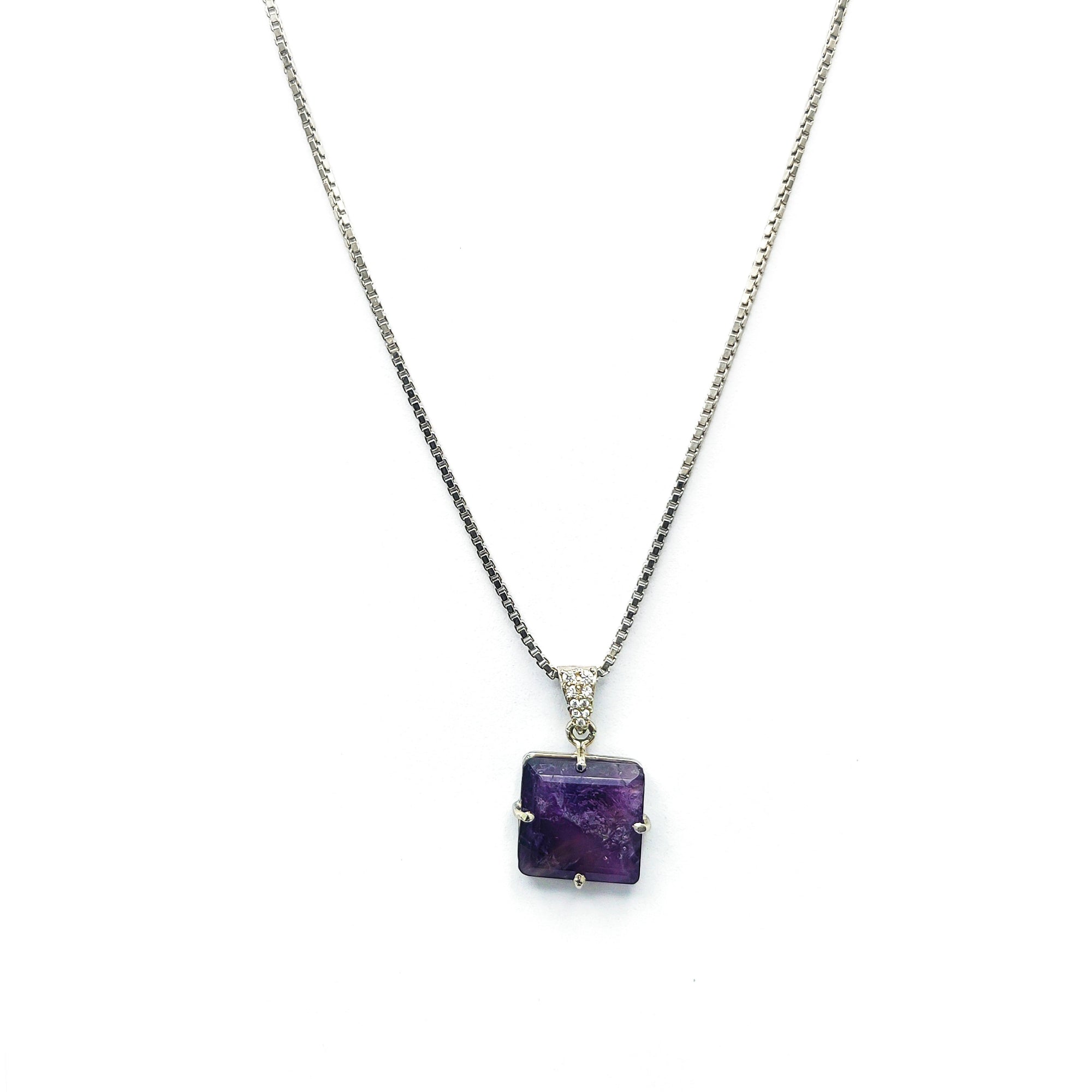 Niz & Aly square-cut amethyst locket pendant on a delicate silver box chain against a white background