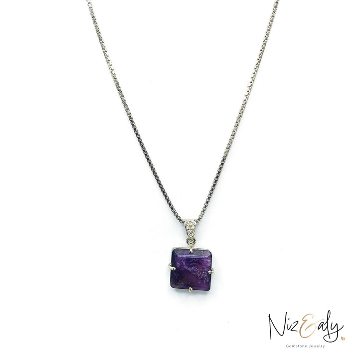 Niz & Aly square-cut amethyst locket pendant on a delicate silver box chain against a white background