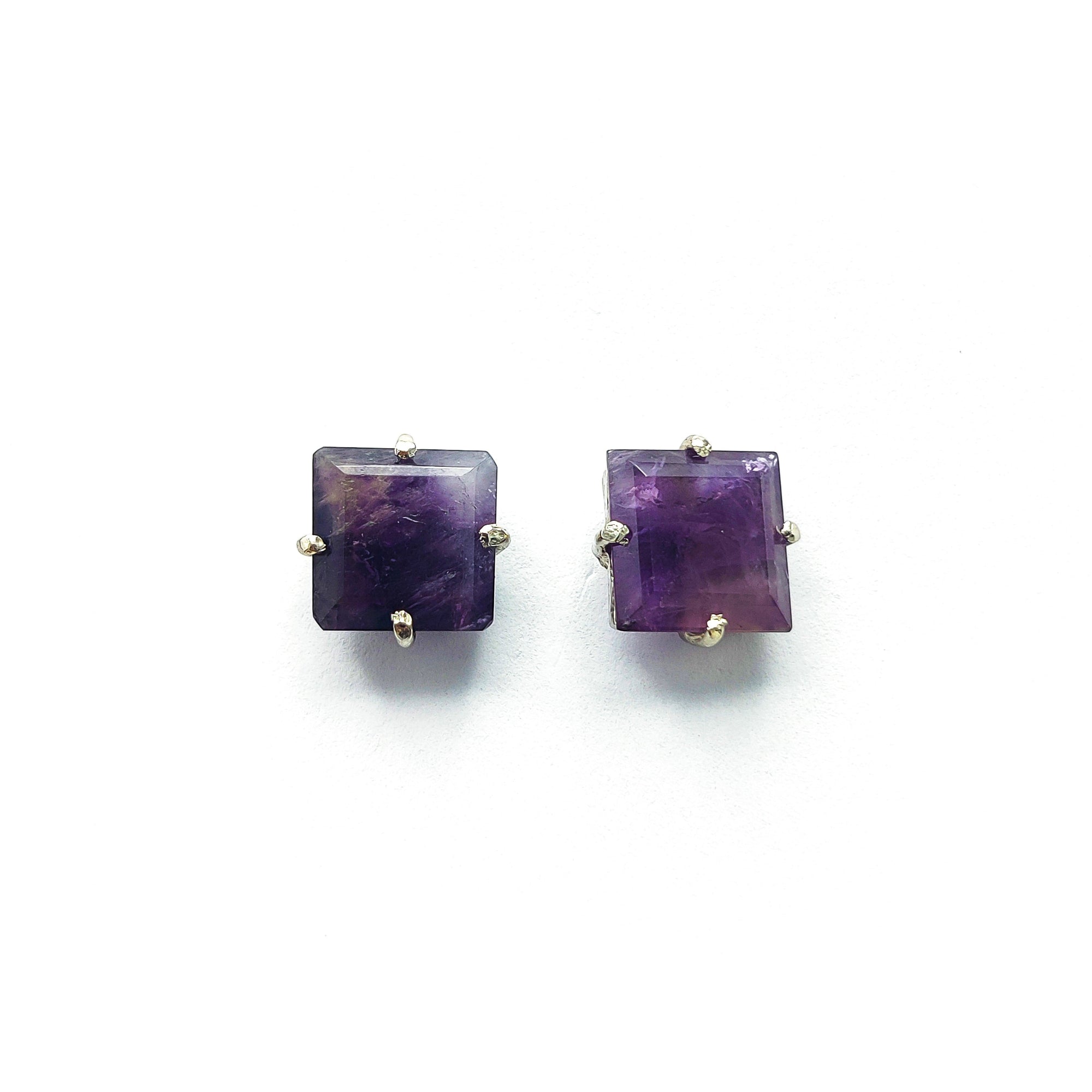 Niz & Aly square-cut amethyst stud earrings with a deep violet hue and silver prong settings on a white background.