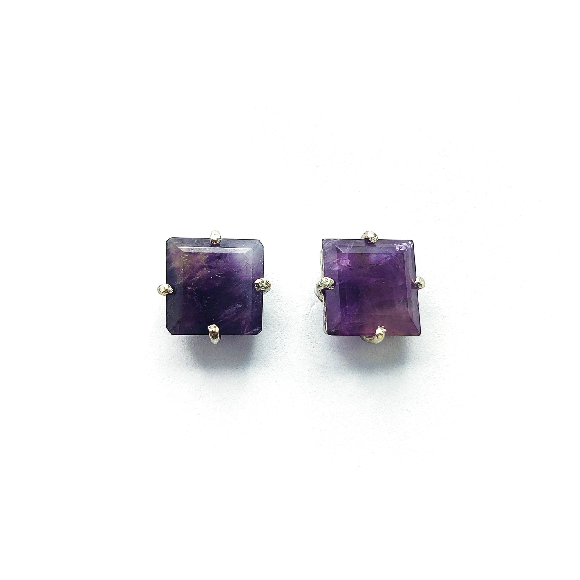 Niz & Aly square-cut amethyst stud earrings with a deep violet hue and silver prong settings on a white background.