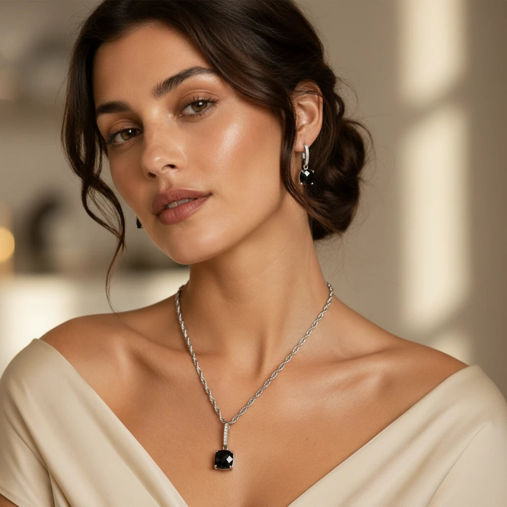 Niz & Aly square black onyx pendant and earring set worn by a woman in a beige dress