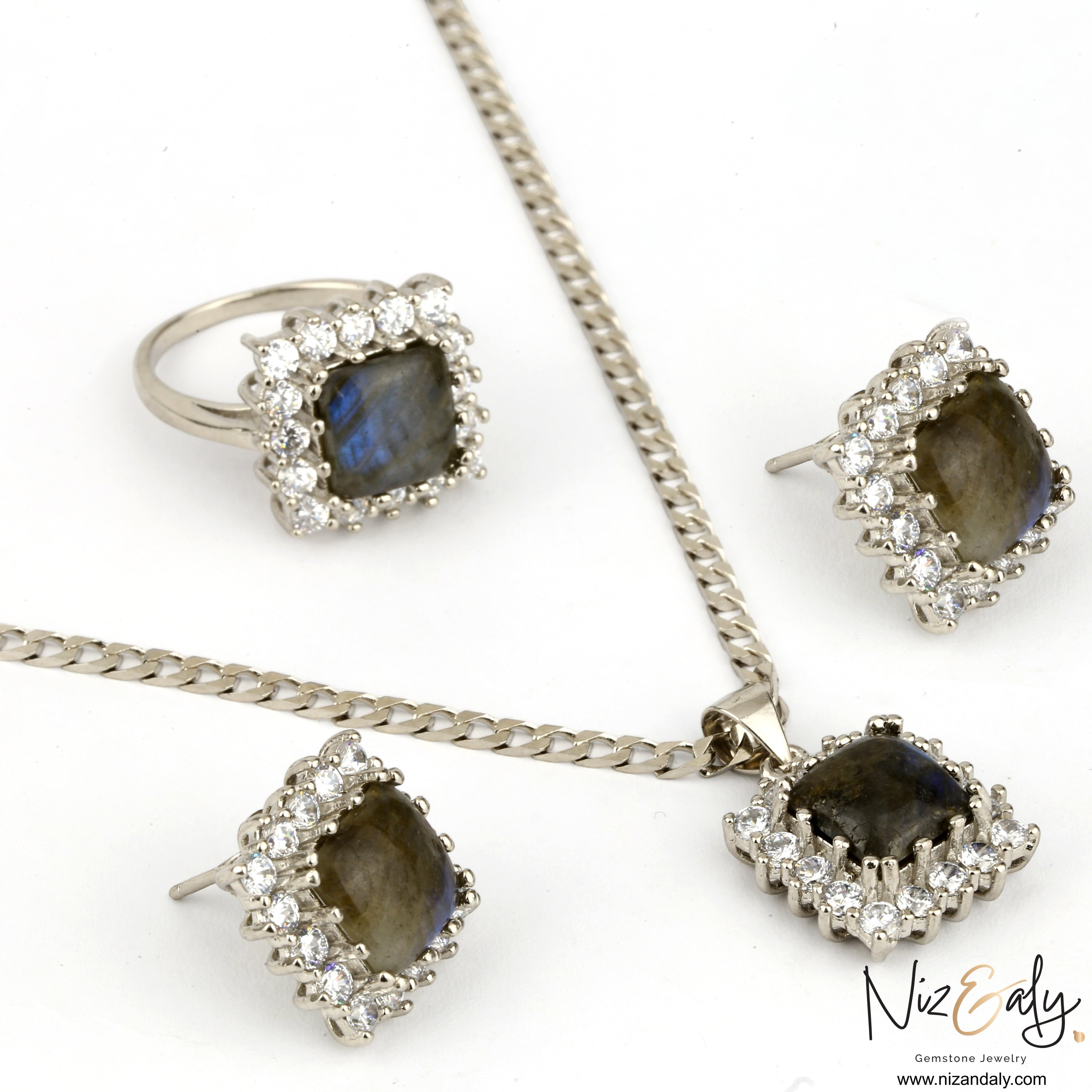 Niz & Aly square labradorite jewelry set featuring a pendant, earrings, and ring with blue fire and crystal halos.