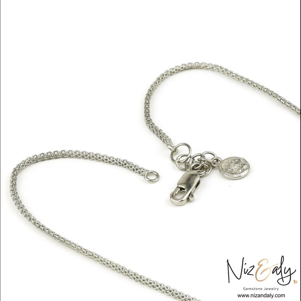 Niz & Aly sterling silver chain necklace with a lobster claw clasp and small round charm on a white background