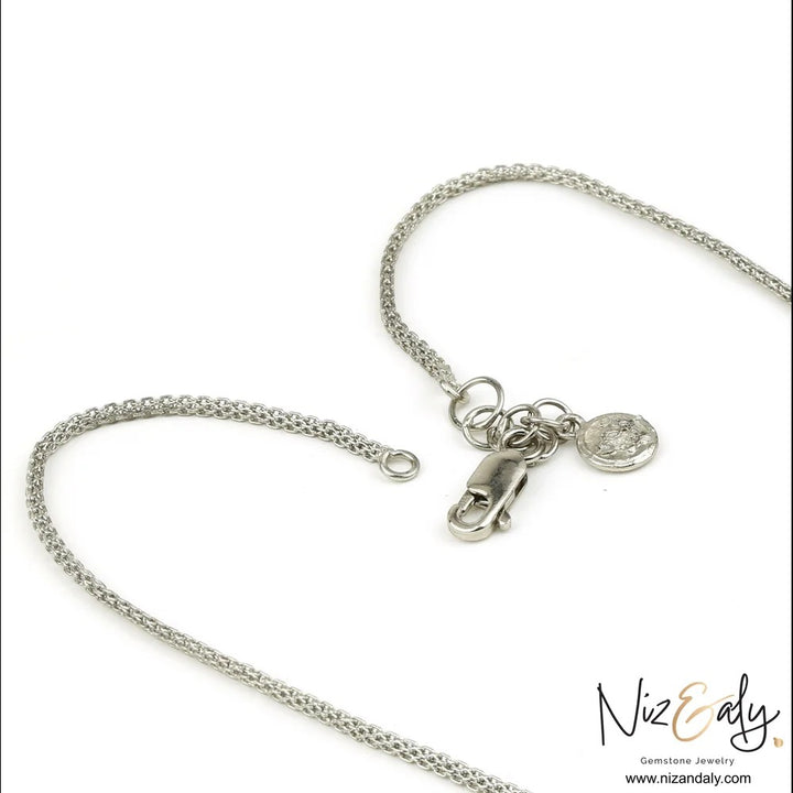 Niz & Aly sterling silver chain necklace with a lobster claw clasp and small round charm on a white background