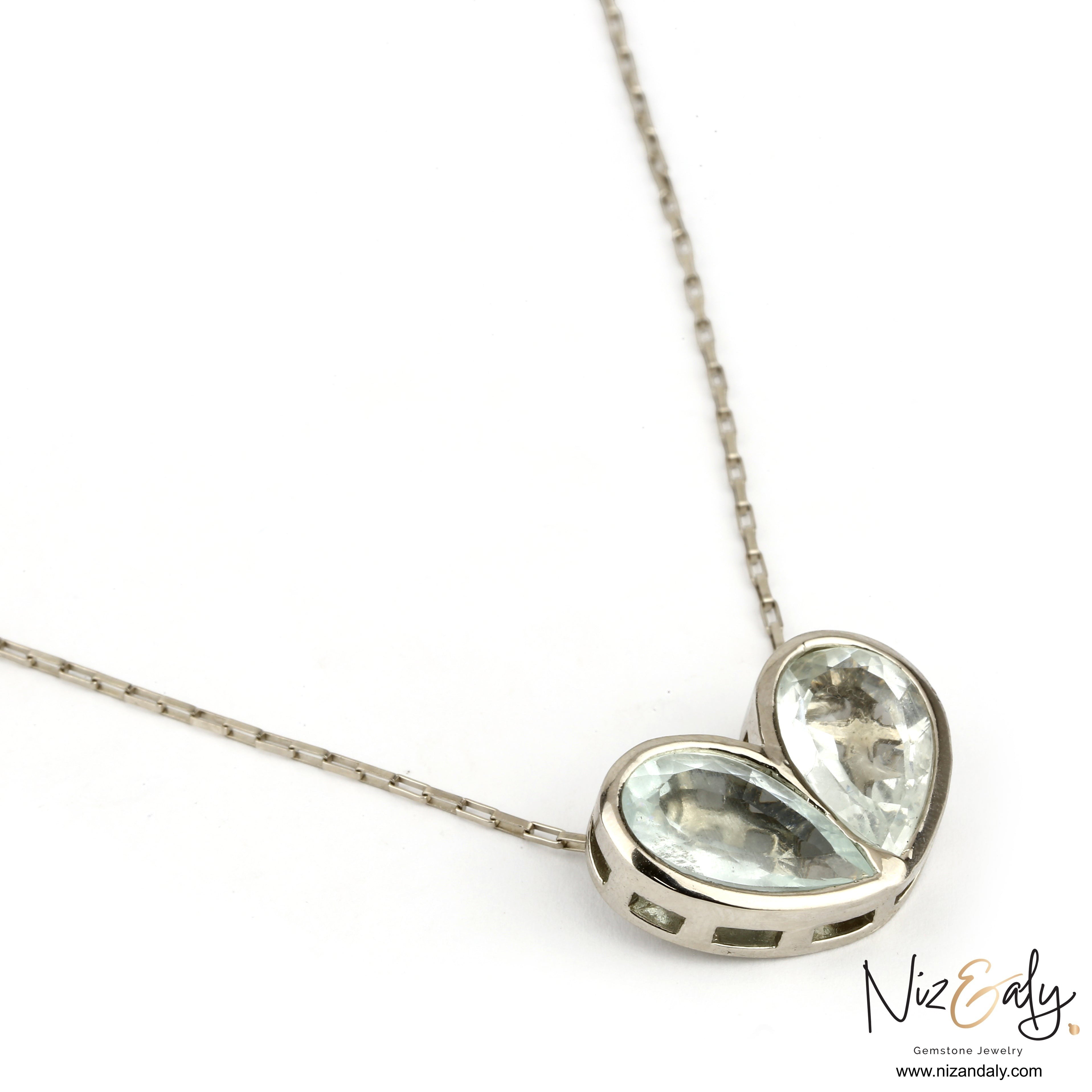 Niz & Aly sterling silver necklace featuring two natural clear quartz heart pendants on a delicate silver chain.