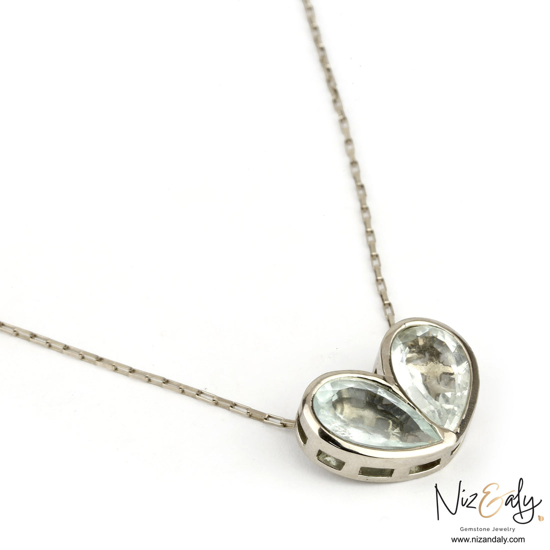 Niz & Aly sterling silver necklace featuring two natural clear quartz heart pendants on a delicate silver chain.