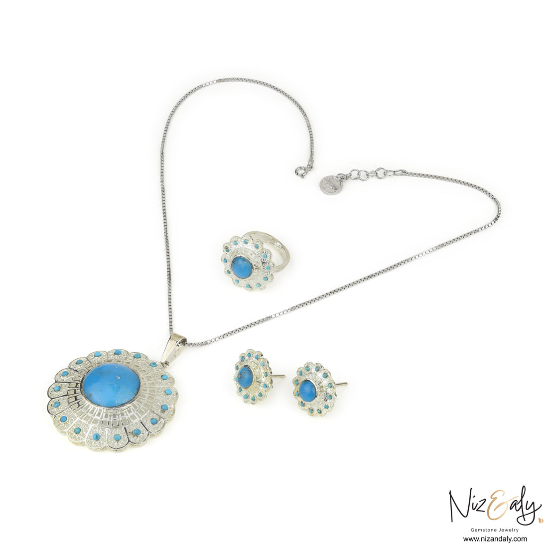Niz & Aly sterling silver jewelry set featuring a floral turquoise pendant, matching earrings, and a ring with filigree.