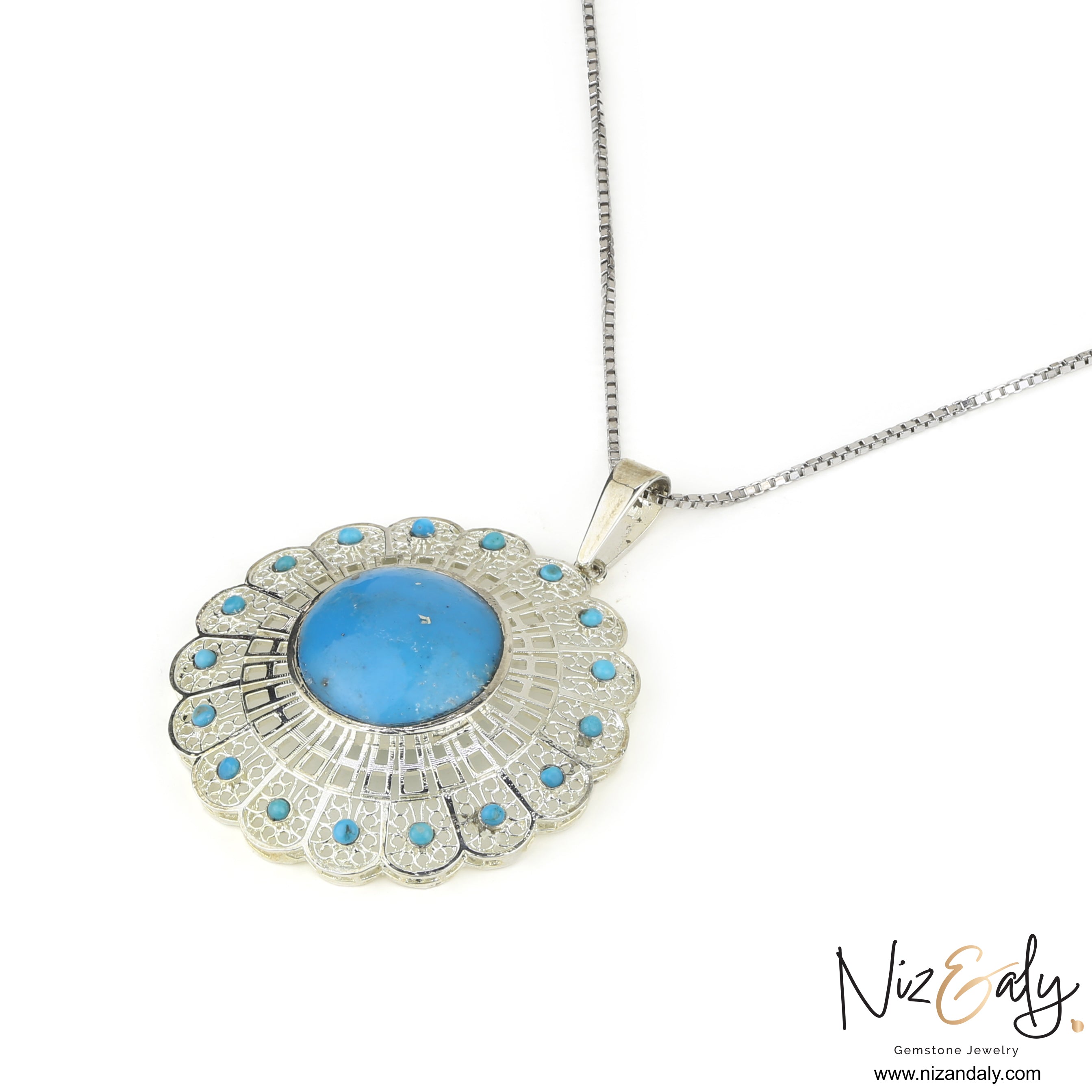 Niz & Aly sterling silver pendant featuring a central blue turquoise stone surrounded by a floral filigree halo.