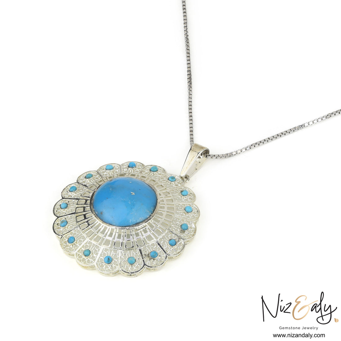 Niz & Aly sterling silver pendant featuring a central blue turquoise stone surrounded by a floral filigree halo.