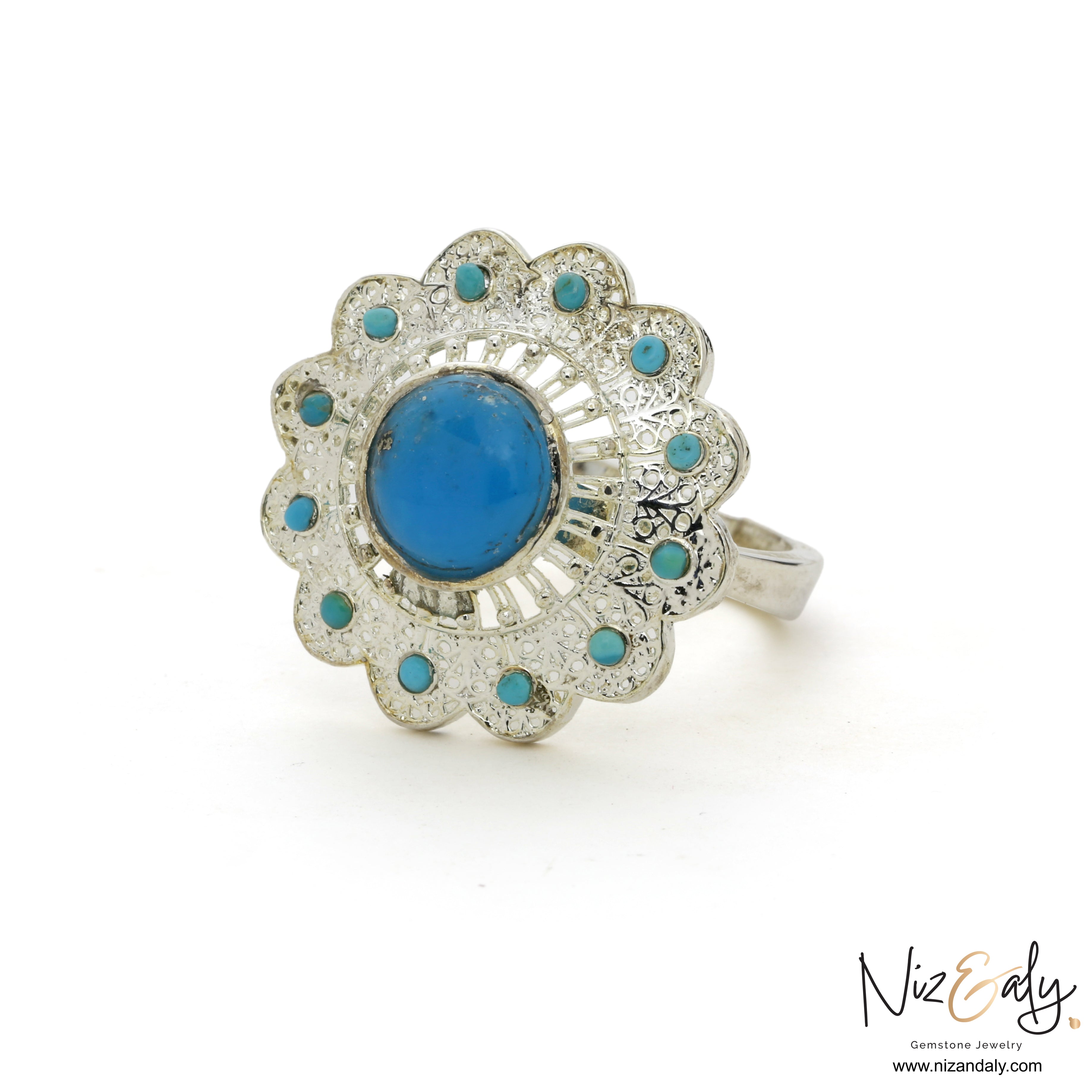 Niz & Aly sterling silver ring featuring a large central turquoise stone surrounded by a floral halo of small gems.