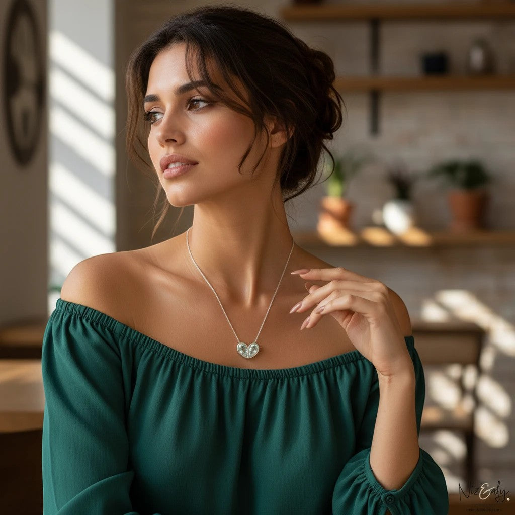 Niz & Aly sterling silver twin heart clear quartz pendant necklace worn by a woman in a green off-shoulder top.