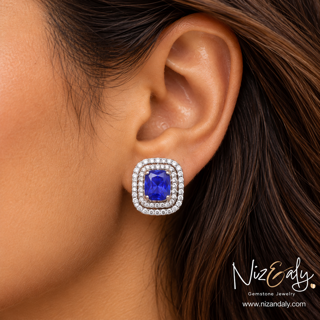 Niz & Aly lavender blue tanzanite stud earring featuring a cushion-cut gemstone with a double halo of sparkling diamonds