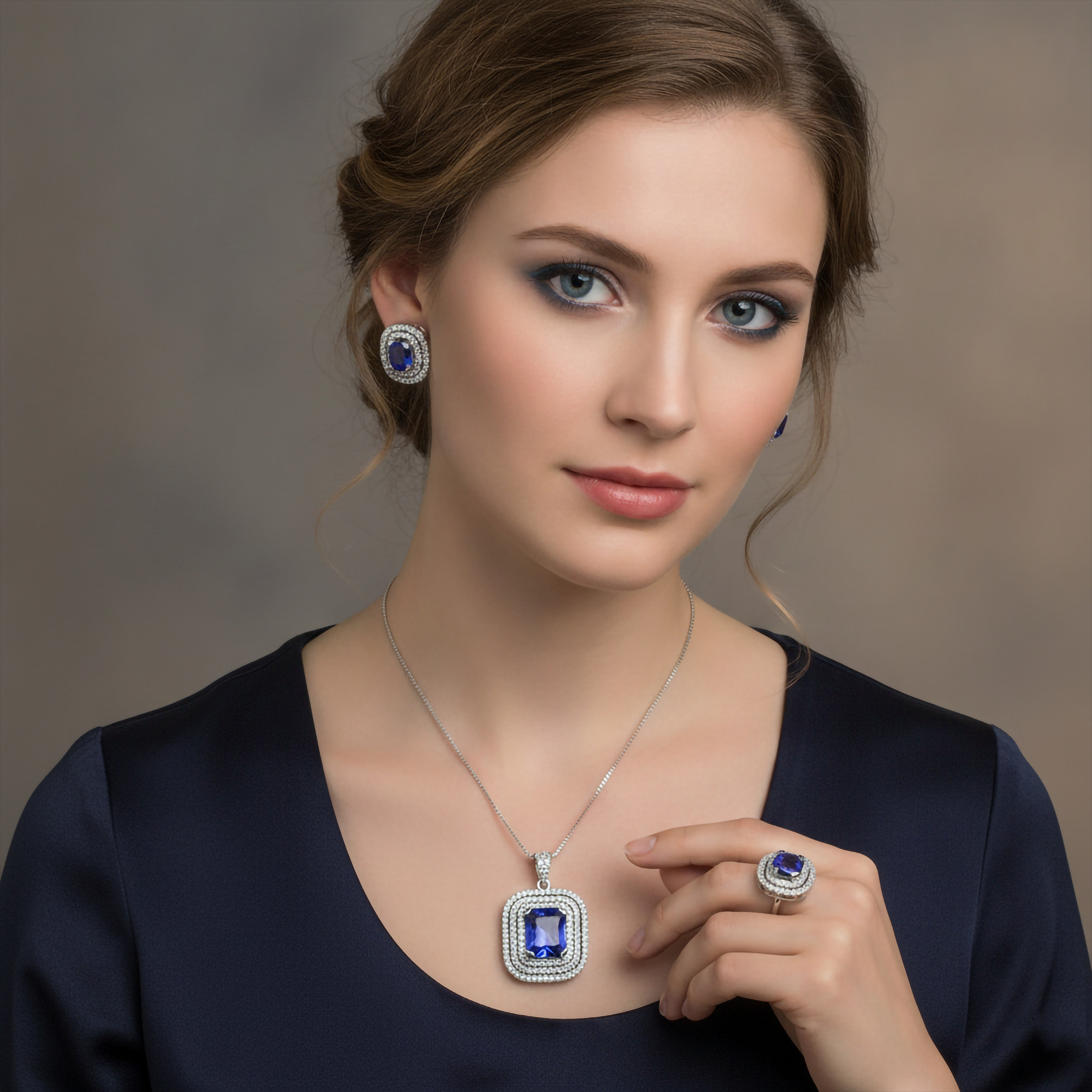 Niz & Aly lavender blue tanzanite jewelry set featuring a pendant, earrings, and ring in sterling silver with halos.