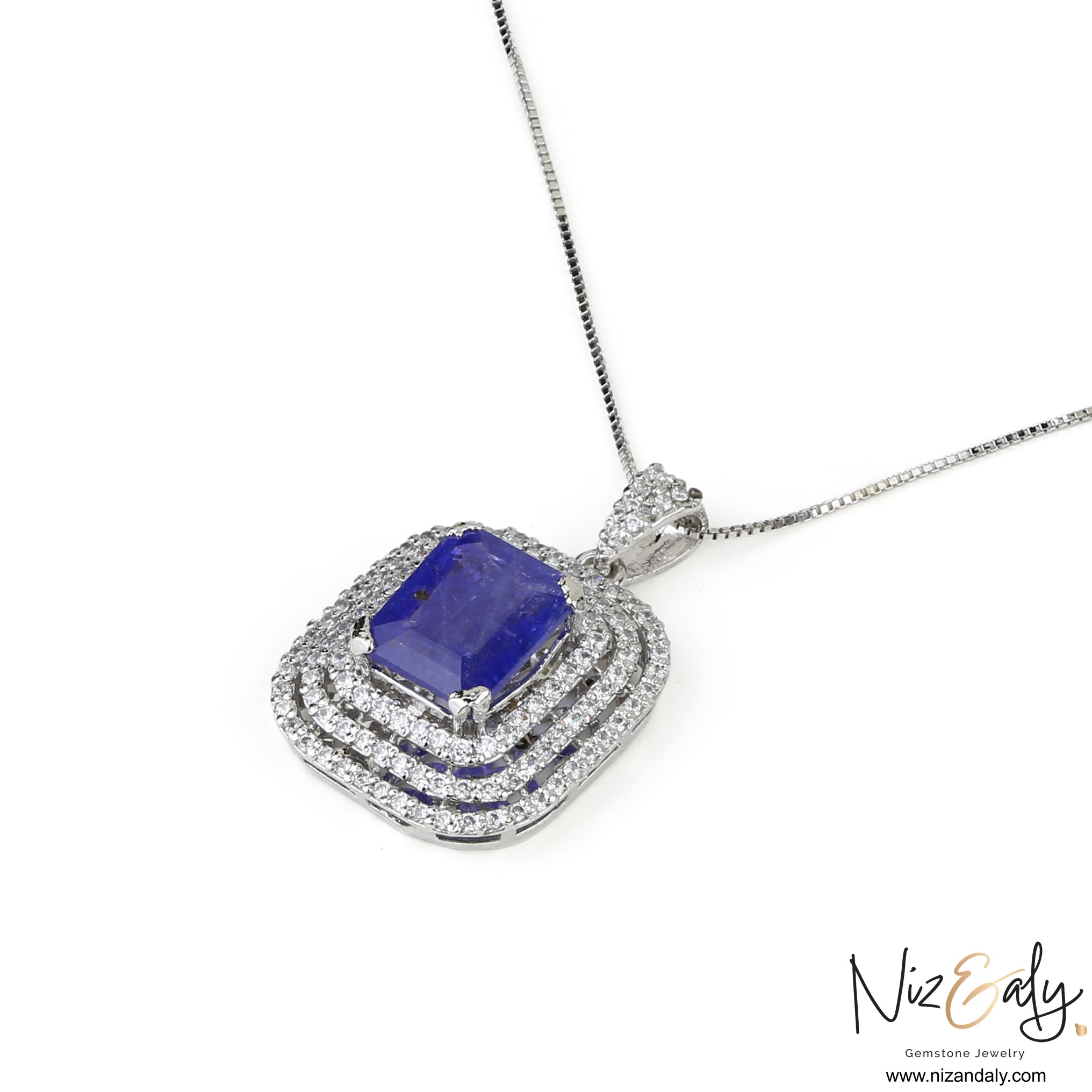 Niz & Aly sterling silver pendant featuring a rectangular blue tanzanite stone surrounded by a double halo of diamonds.
