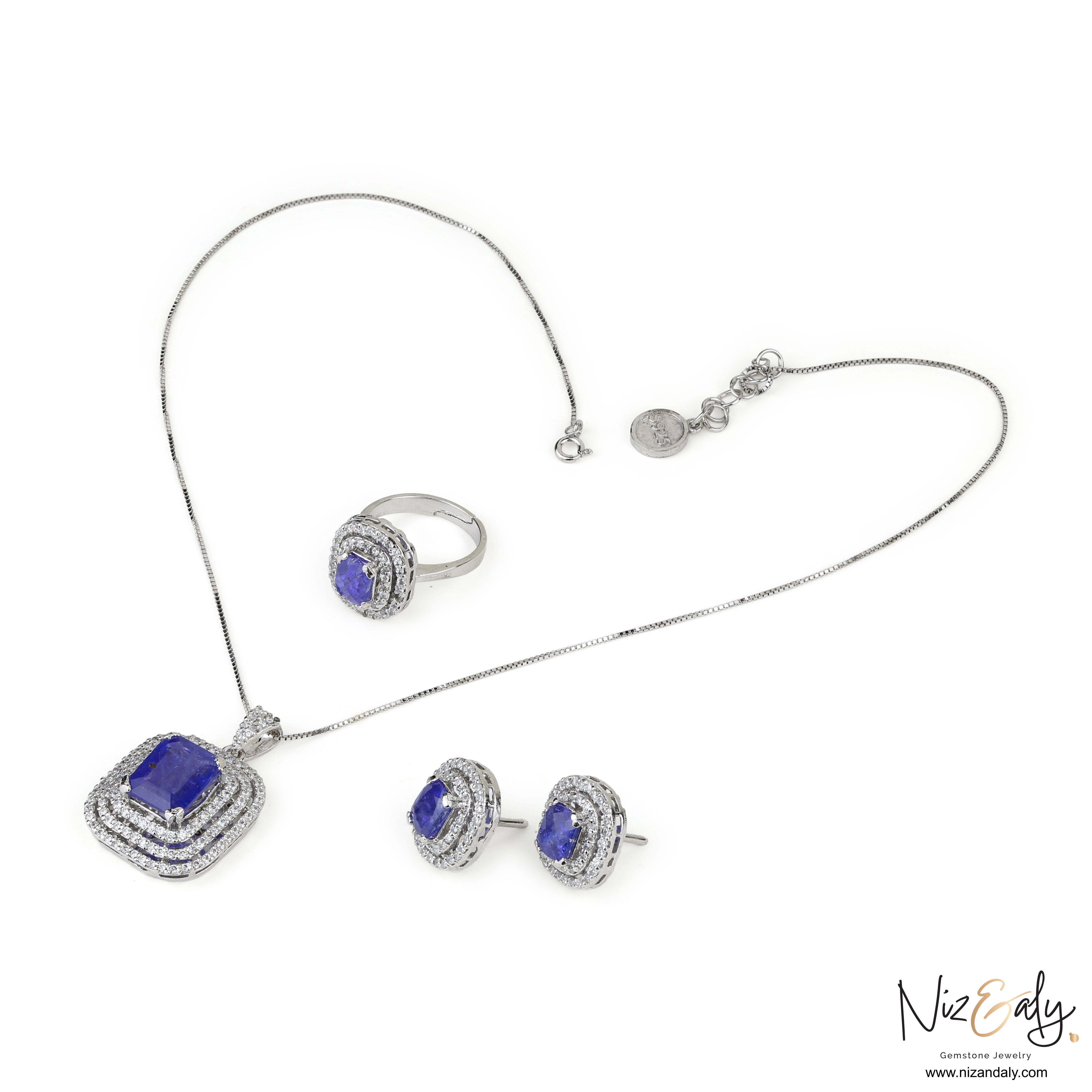 Niz & Aly lavender blue tanzanite jewelry set featuring a pendant, earrings, and ring in sterling silver with halos.