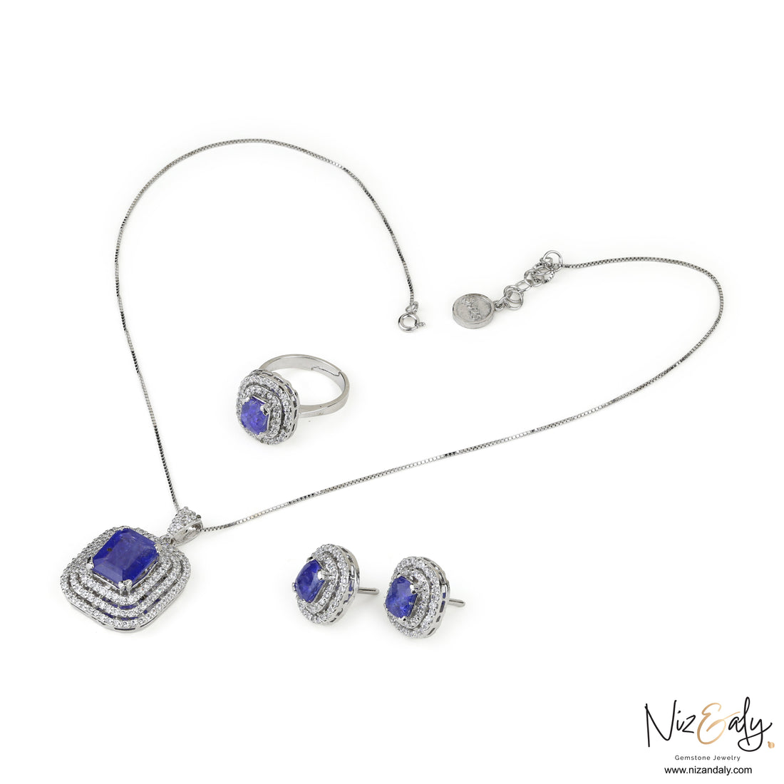 Niz & Aly lavender blue tanzanite jewelry set featuring a pendant, earrings, and ring in sterling silver with halos.