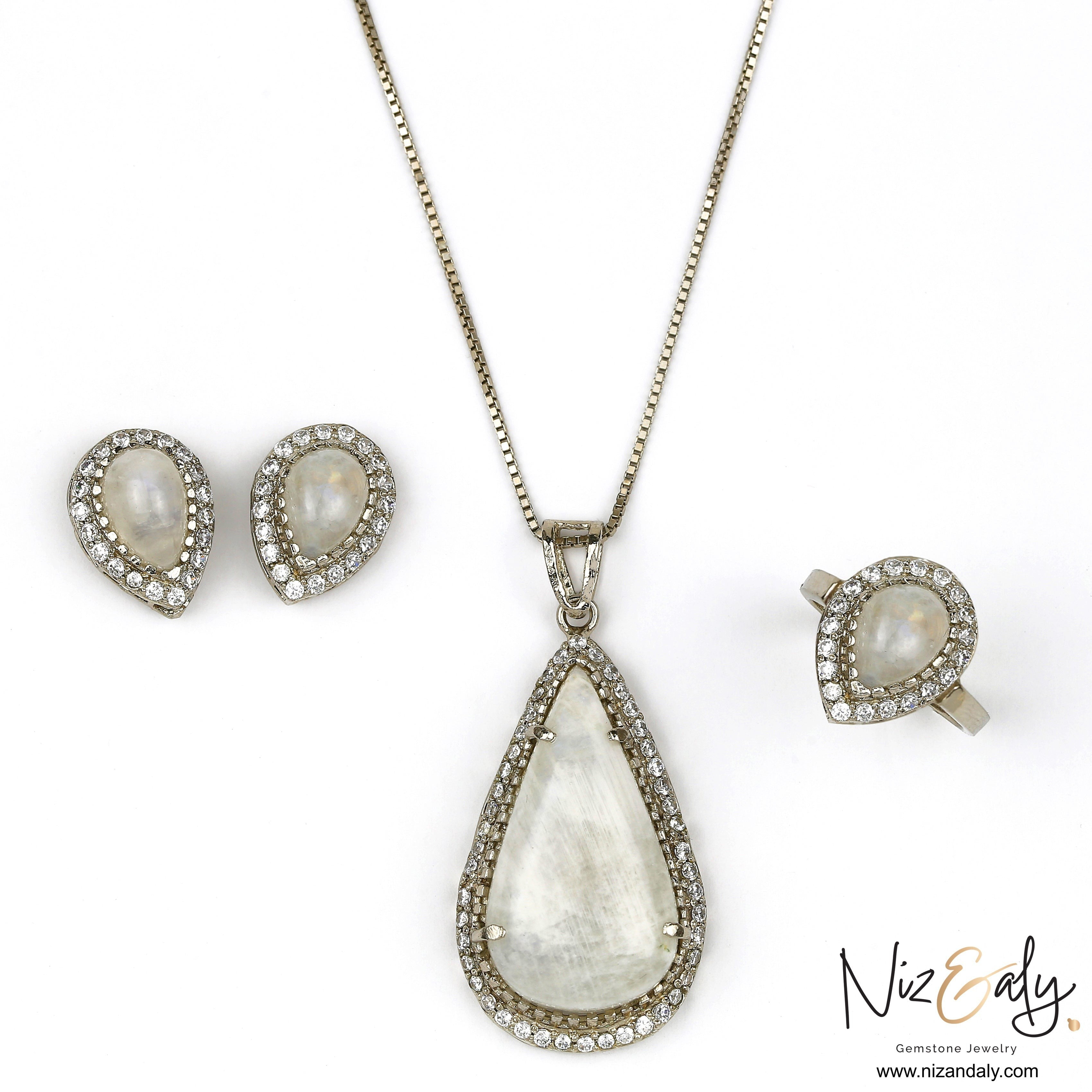 Niz & Aly teardrop moonstone pendant, ring, and earring set with blue flash and sparkling halo accents.