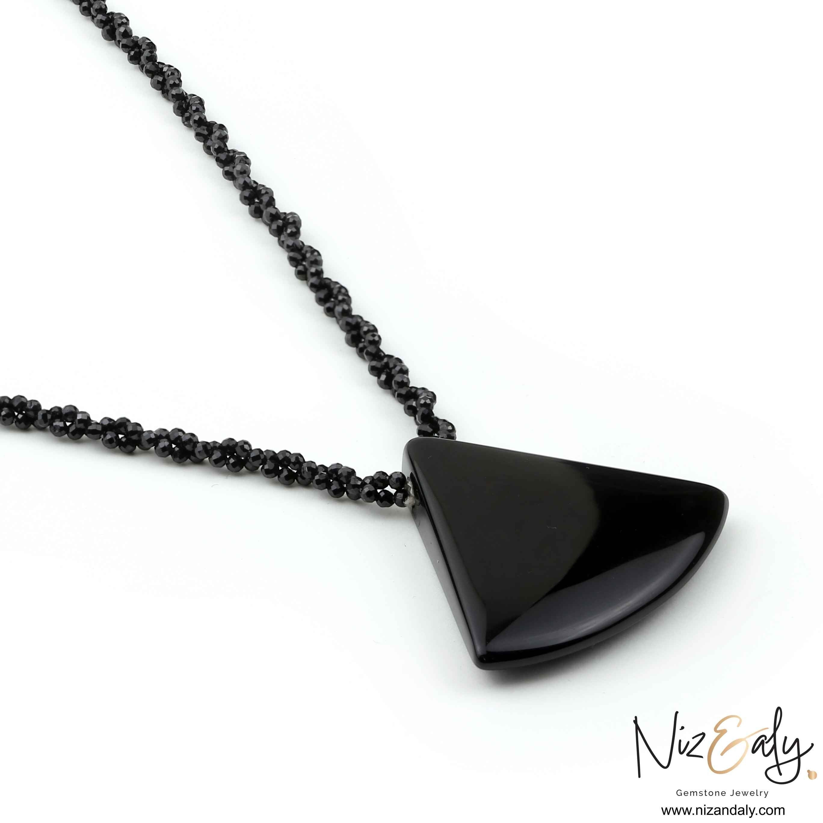 Niz & Aly Agate Eclipse necklace featuring a smooth triangular black agate pendant on a twisted black onyx bead chain.