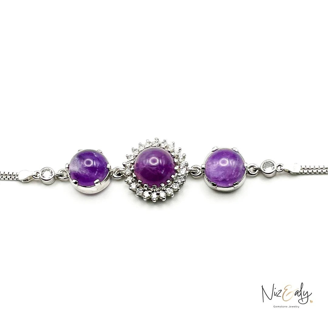 Niz & Aly triple amethyst bracelet featuring three purple cabochon gemstones set in silver with sparkling accents.