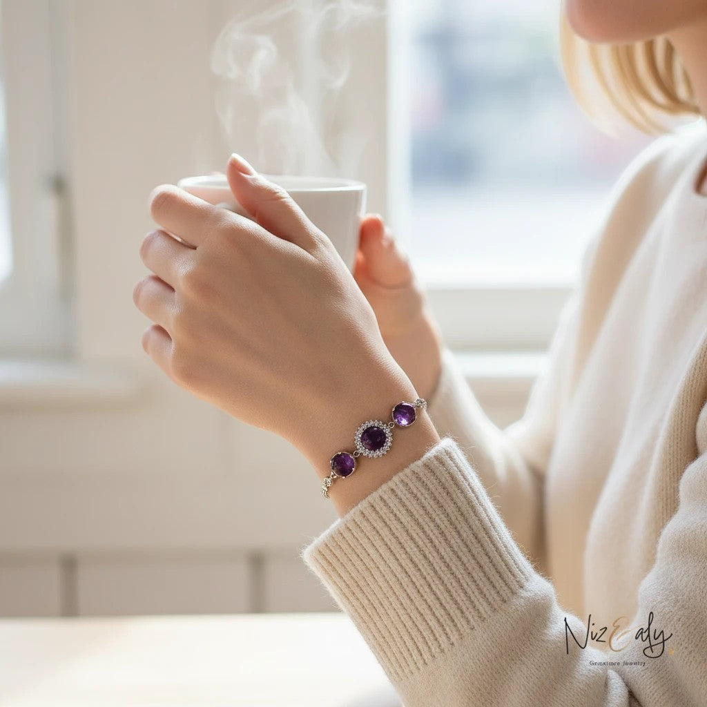Niz & Aly triple amethyst bracelet featuring faceted purple gemstone beads on a silver chain worn on a woman's wrist.
