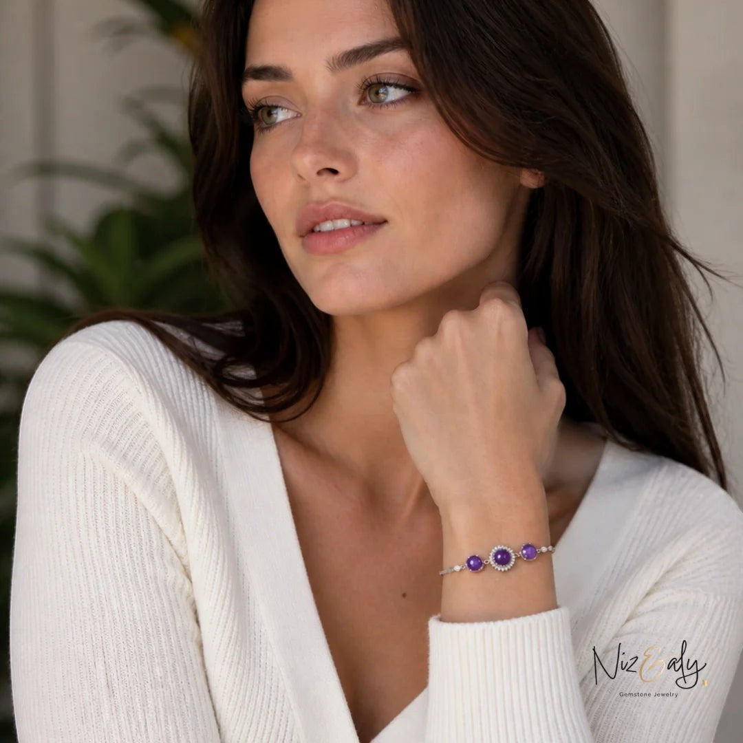 Niz & Aly triple amethyst bracelet featuring purple faceted crystal beads on a model wearing a white ribbed top.