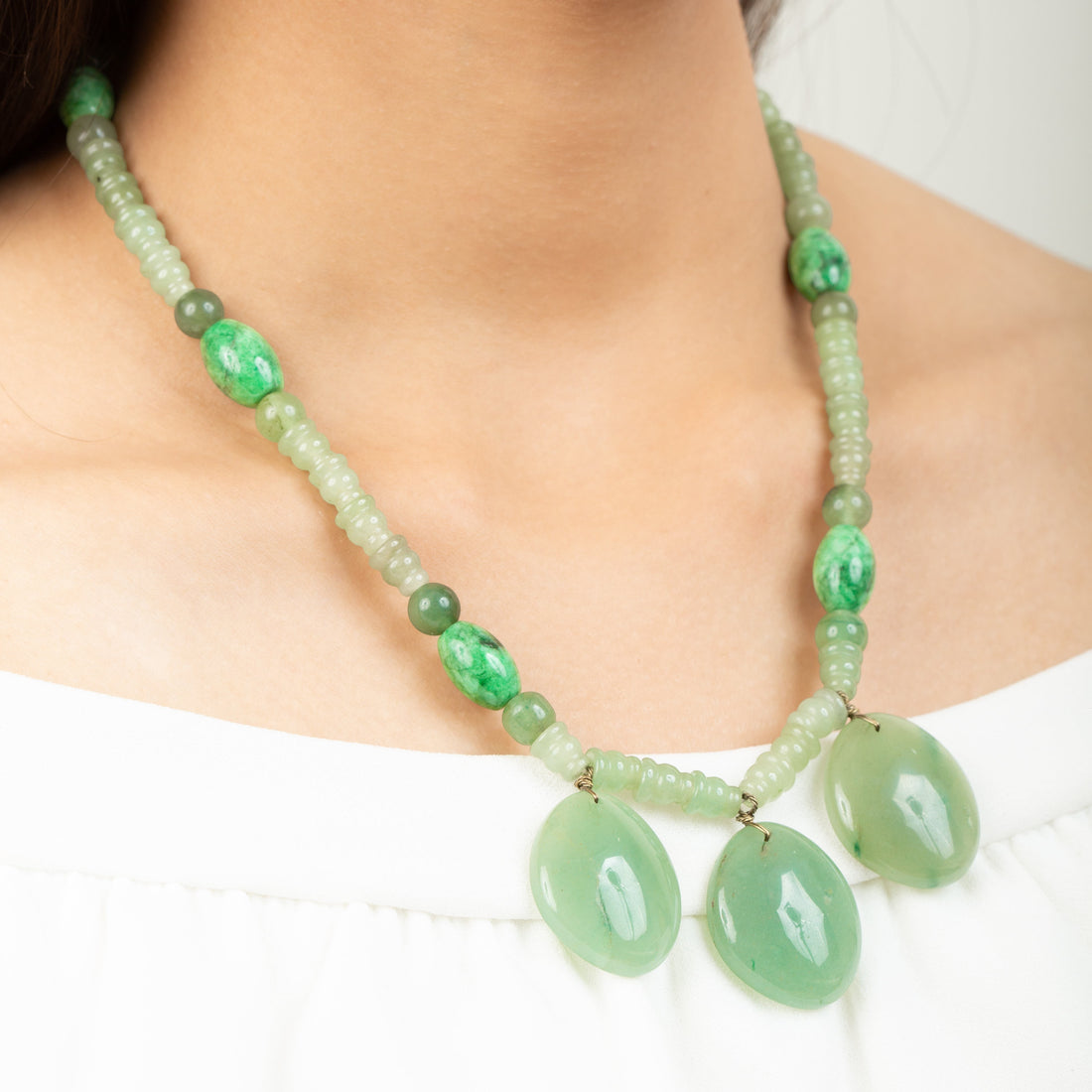 Niz & Aly triple charm aventurine necklace featuring polished green gemstone pendants on a beaded chain.