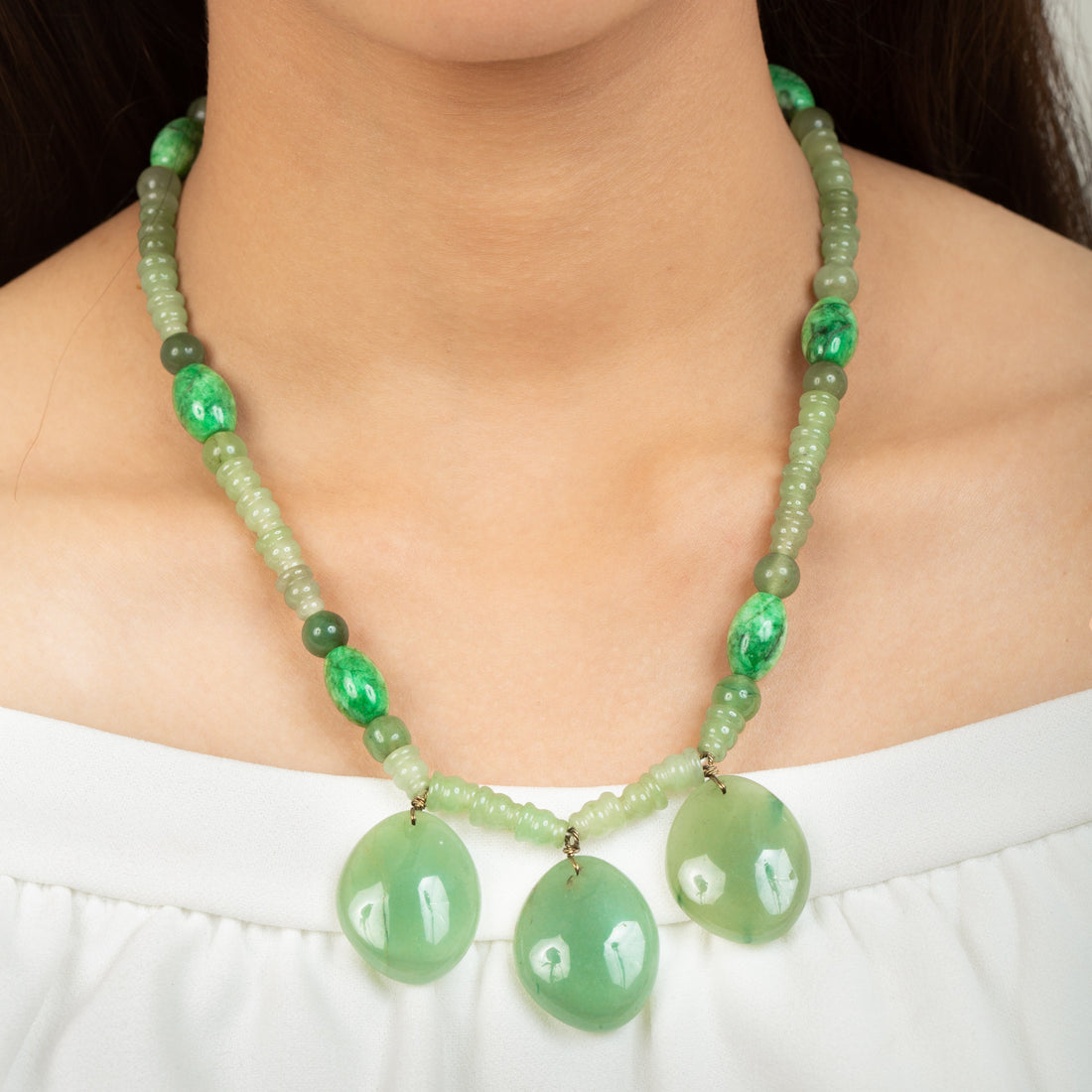 Niz & Aly triple charm aventurine necklace featuring polished green gemstone pendants on a beaded green stone chain.