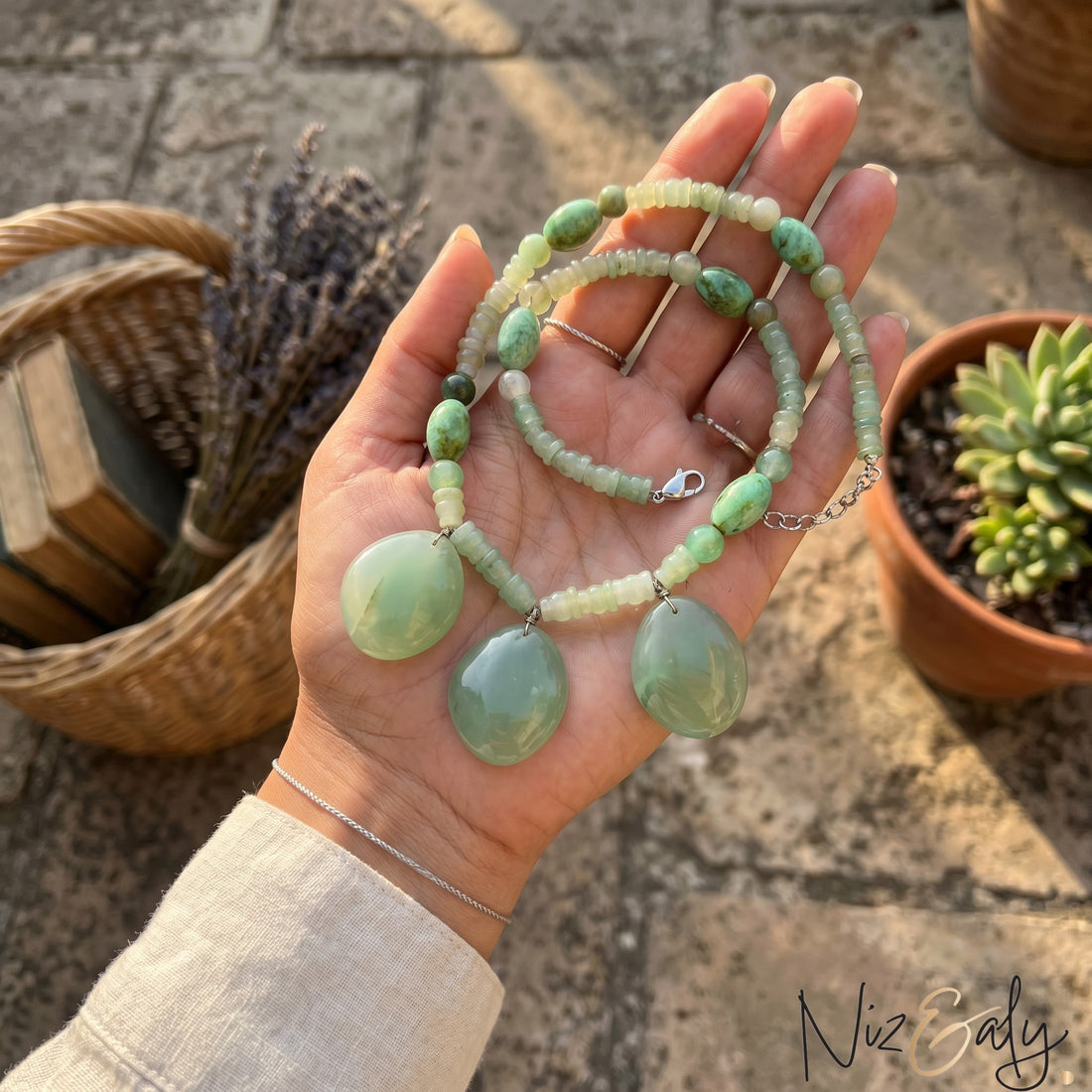 Niz & Aly triple charm aventurine necklace featuring polished green gemstone pendants on a beaded chain.