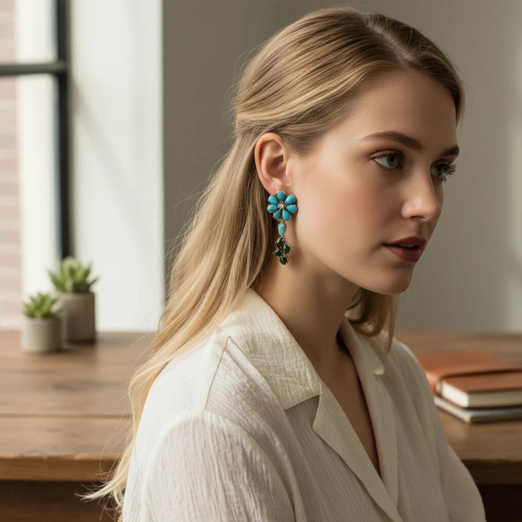 Niz & Aly Dessert Bloom turquoise flower chandelier earrings worn by a woman in a white shirt