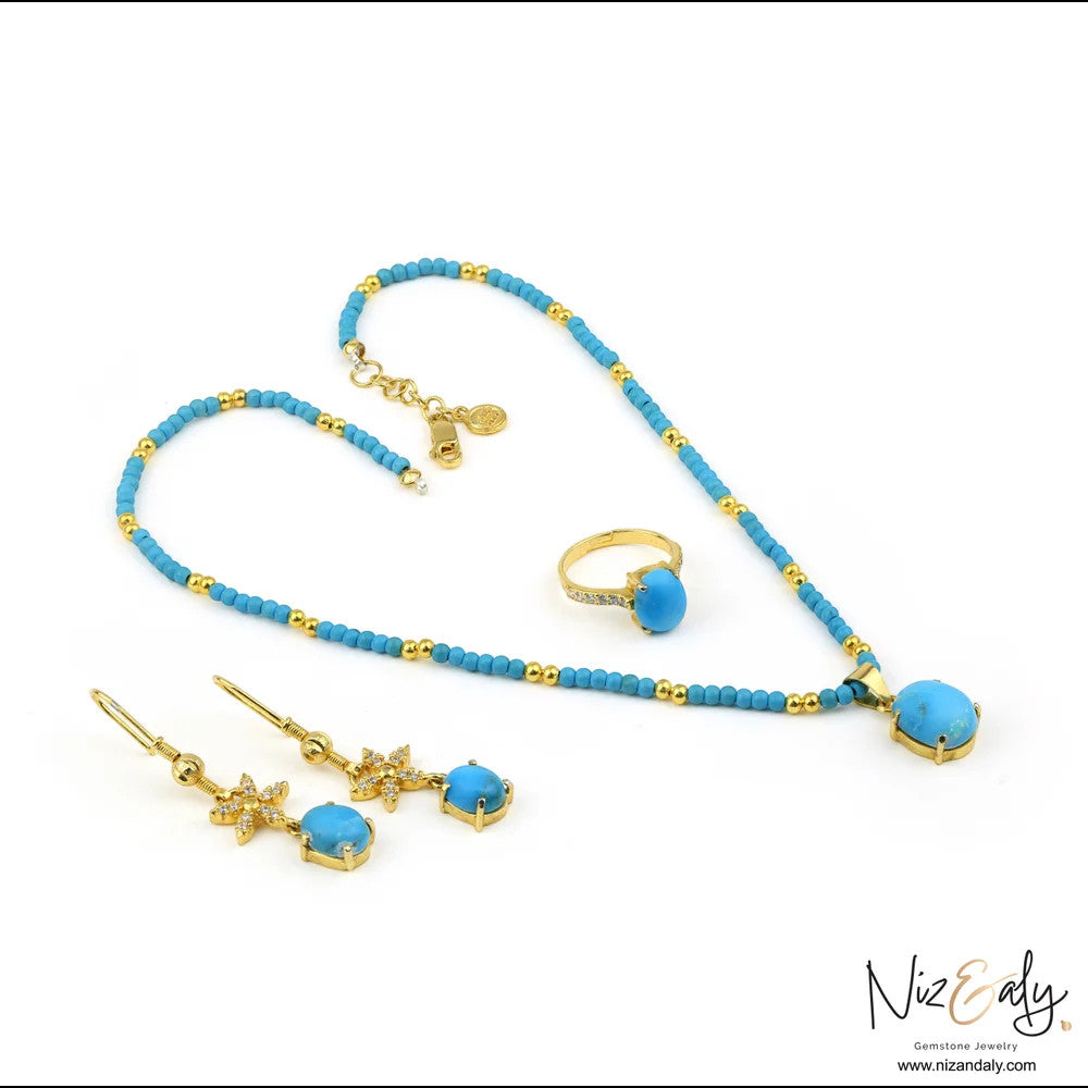 Niz & Aly turquoise gemstone jewelry set with gold-tone necklace, crystal-accented drop earrings, and matching ring.