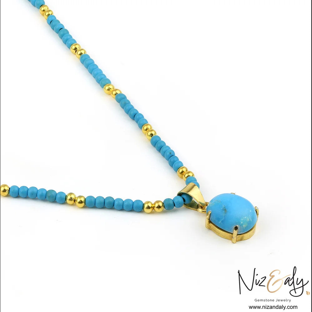 Niz & Aly turquoise gemstone pendant necklace with gold-tone beaded chain and polished metal setting