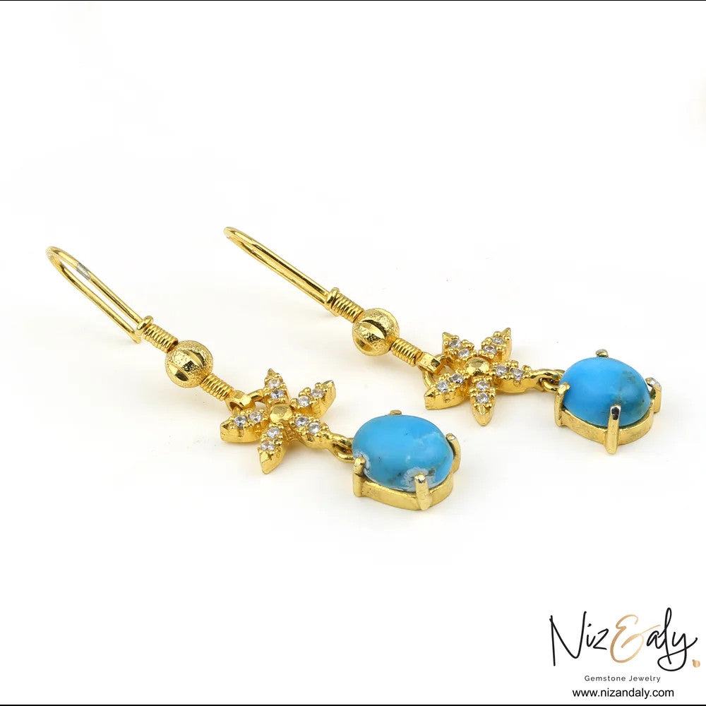 Niz & Aly gold-tone drop earrings featuring turquoise cabochon gemstones and crystal-encrusted floral accents
