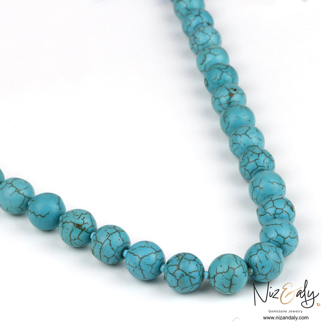Niz & Aly turquoise howlite beaded necklace with marbled sky-blue round stones on a white background.