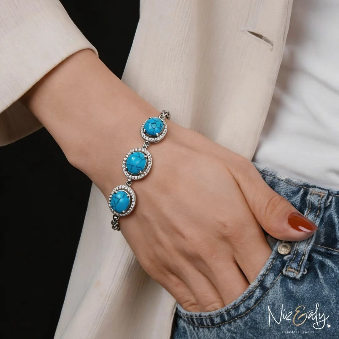 Niz & Aly turquoise blue howlite gemstone bracelet with silver-tone halo setting on a woman's wrist