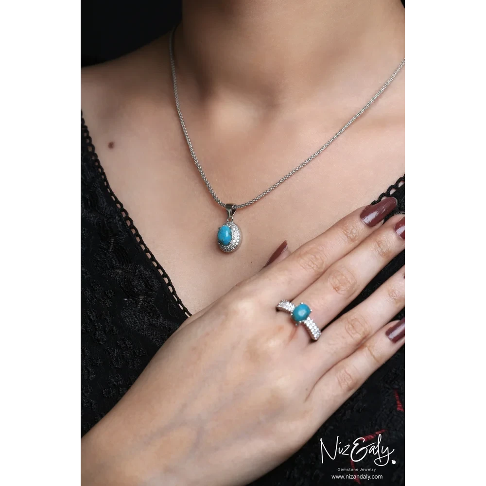 Niz & Aly oval turquoise necklace and ring set with white cubic zirconia halo in a silver-toned setting on a model