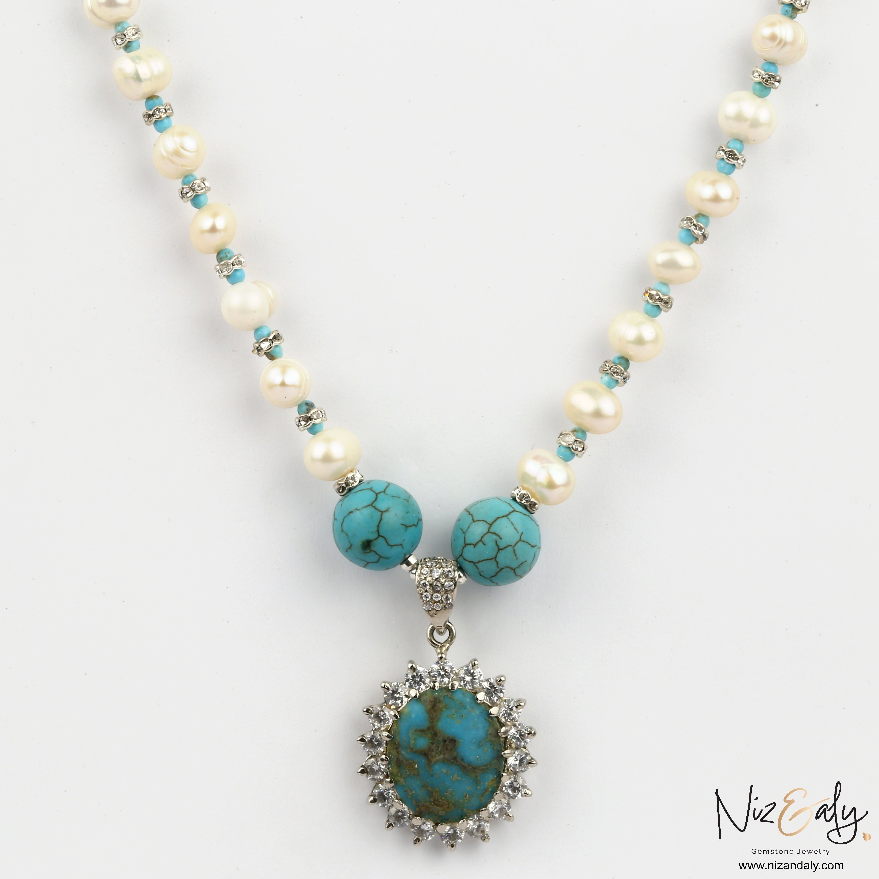 Niz & Aly Sky Vein-Kingman turquoise pendant necklace with white pearls and ornate silver setting on a white background