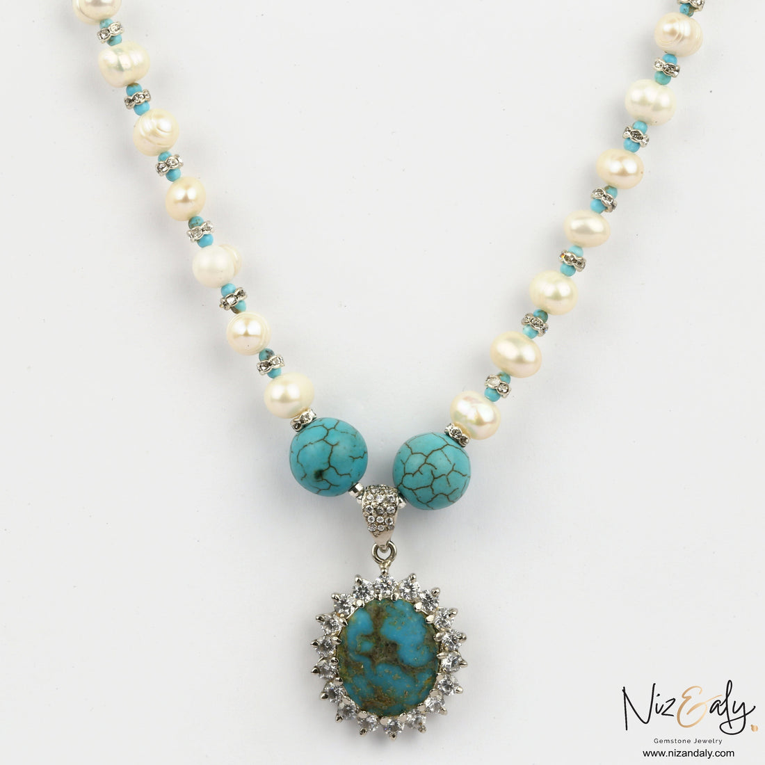 Niz & Aly Sky Vein-Kingman turquoise pendant necklace with white pearls and ornate silver setting on a white background