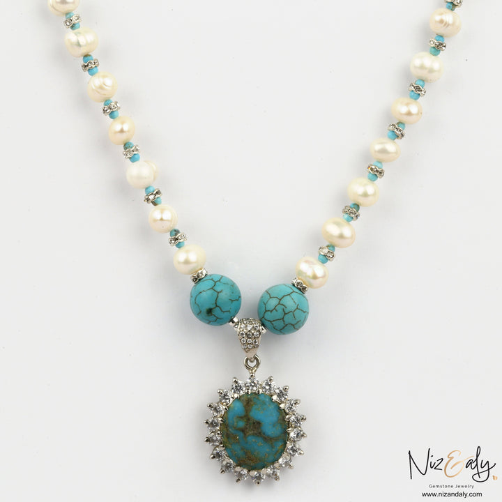 Niz & Aly Sky Vein-Kingman turquoise pendant necklace with white pearls and ornate silver setting on a white background
