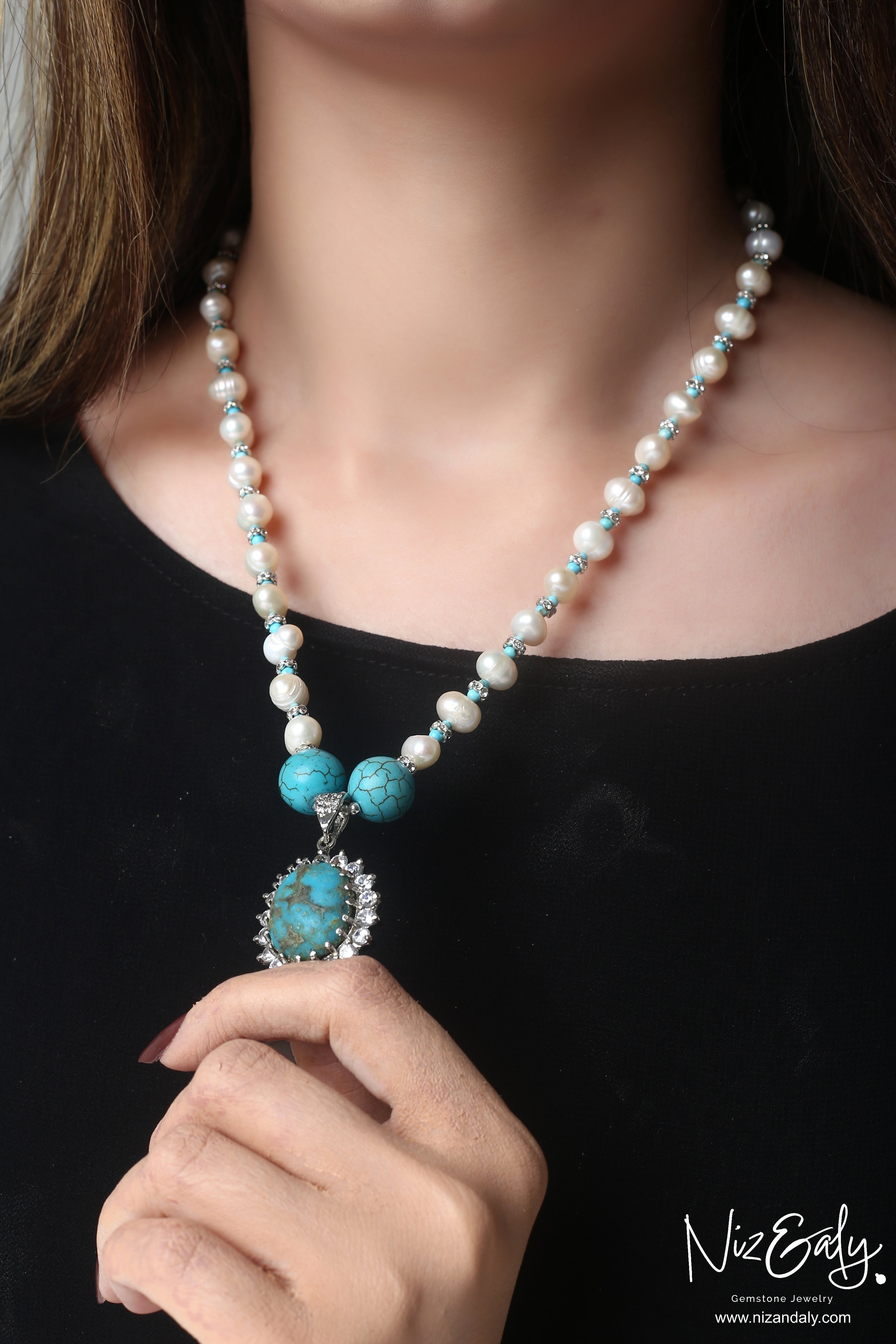 Niz & Aly necklace featuring a Kingman turquoise pendant in ornate silver with white pearl and turquoise bead accents.