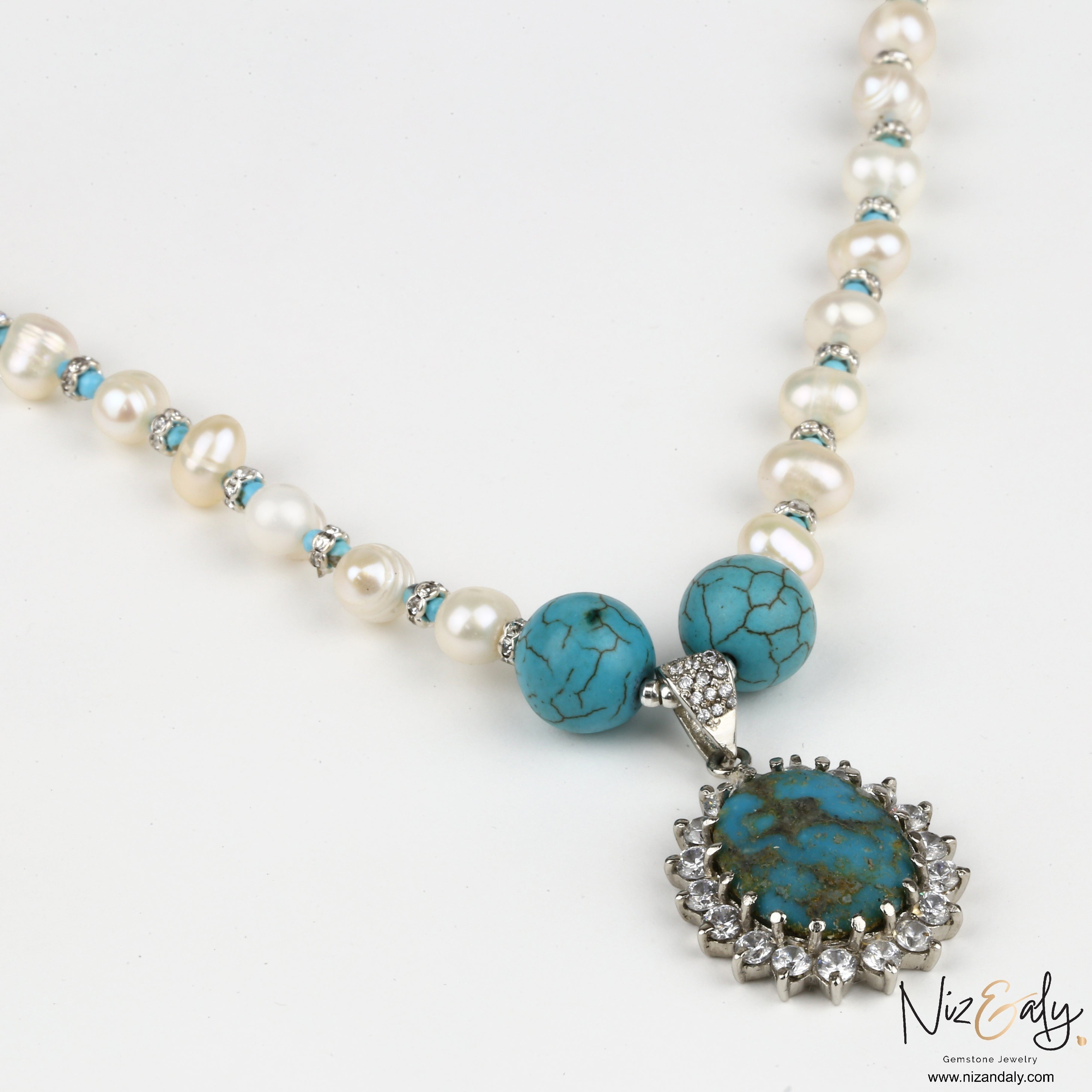Niz & Aly necklace featuring a Kingman turquoise pendant with silver and pearl beads on a white background.
