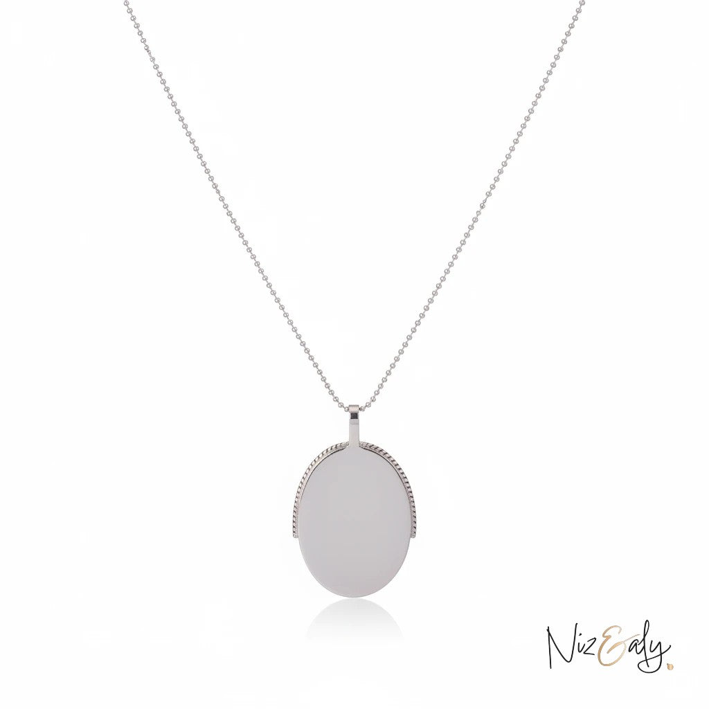 Niz & Aly turquoise and pyrite pendant necklace on a delicate silver chain, featuring a boho-inspired oval design.