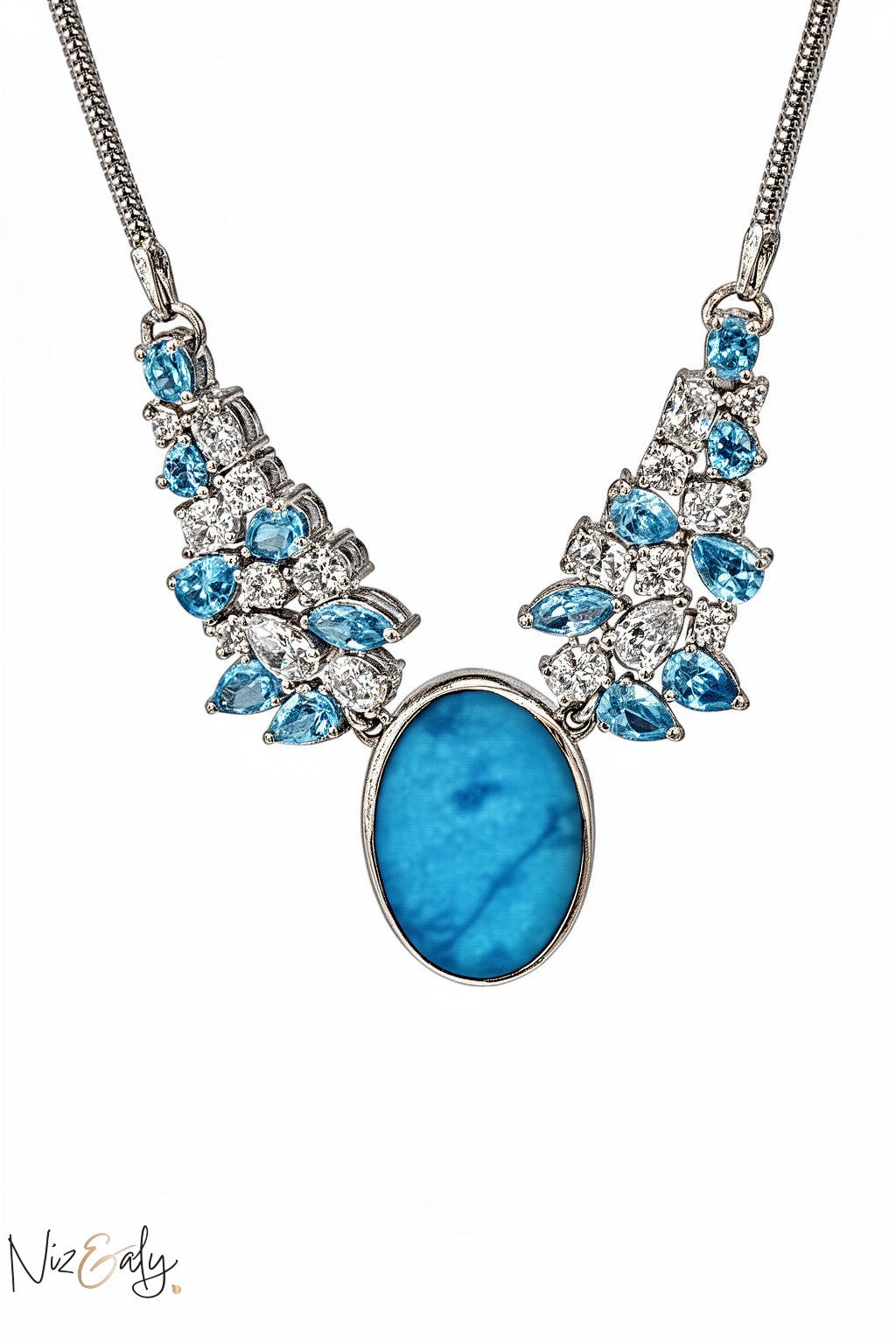 Niz & Aly statement necklace featuring a large oval natural turquoise stone accented with blue and white crystals.