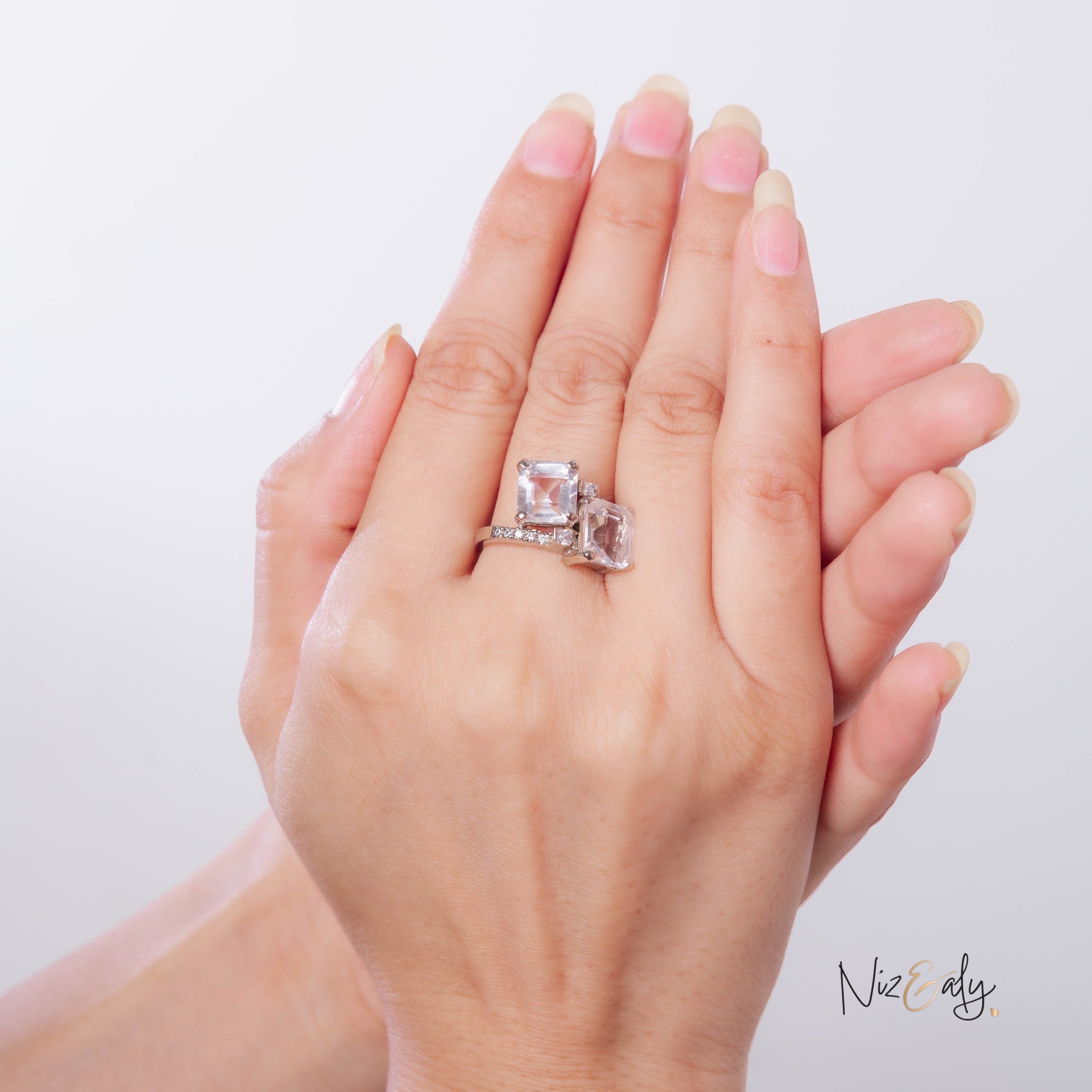 Niz & Aly twin clear quartz ring featuring two square-cut stones on a polished silver band worn on a hand