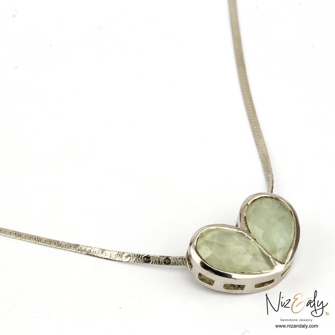 Niz & Aly twin heart pendant necklace featuring faceted pale green prehnite gemstones set in a silver chain.