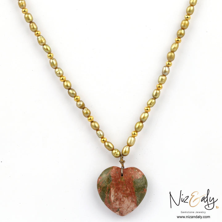Niz & Aly unakite heart pendant necklace featuring a strand of golden rice pearls and small gold beads.