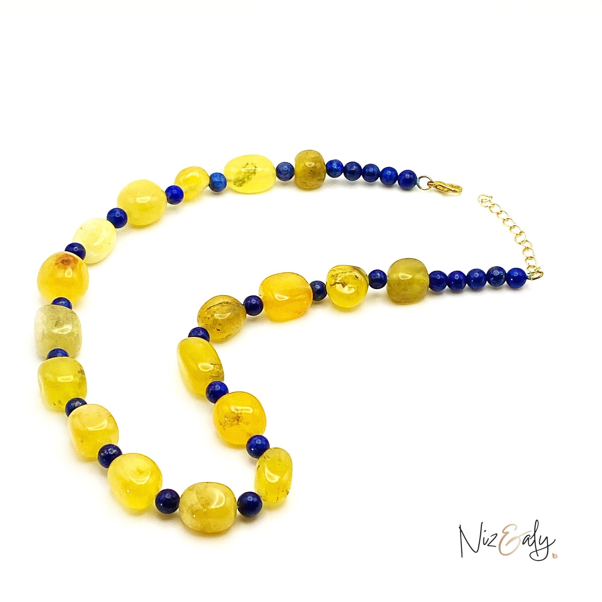 Niz & Aly necklace featuring polished yellow agate nuggets and small blue lapis lazuli beads with a gold-tone clasp.