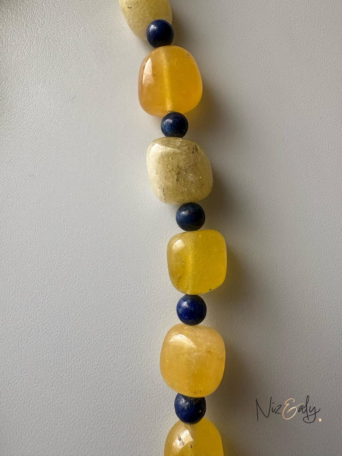 Niz & Aly necklace featuring alternating tumbled yellow agate and small round blue lapis lazuli gemstone beads.